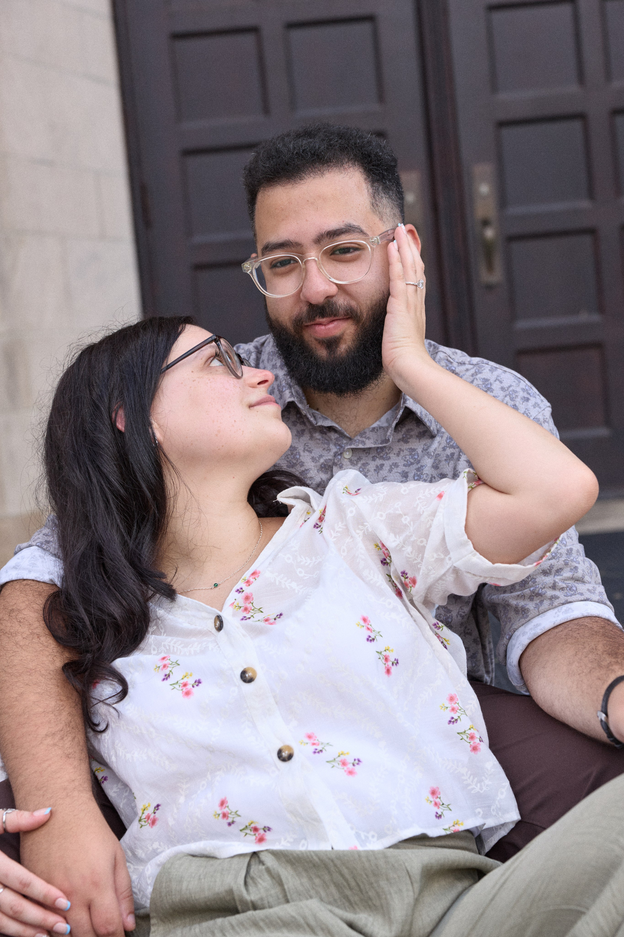 Laughing couple sitting together after the proposal at Capital University in Columbus, Ohio