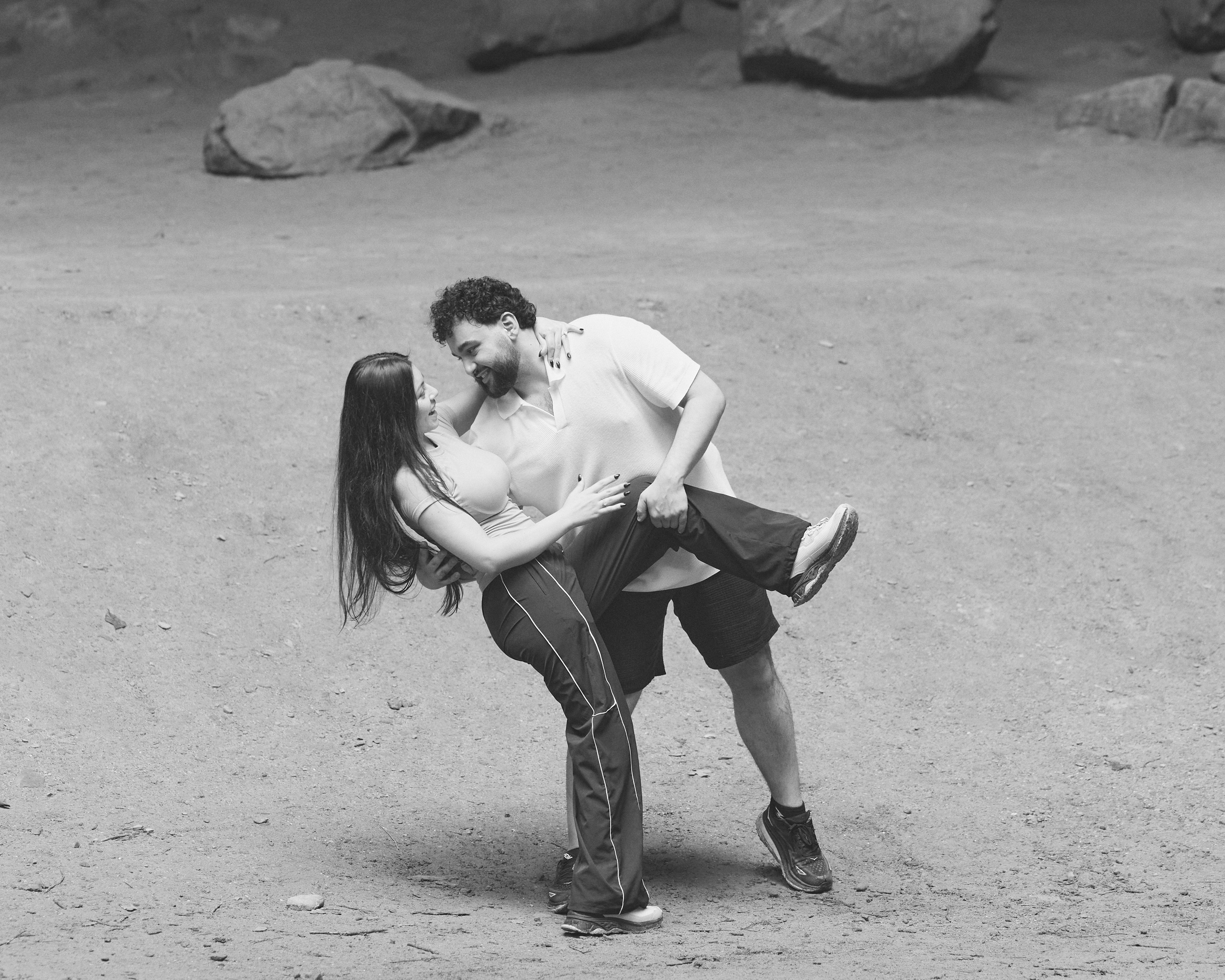 Black and white photo of a groom lifting his bride for a kiss in Hocking Hills, Ohio