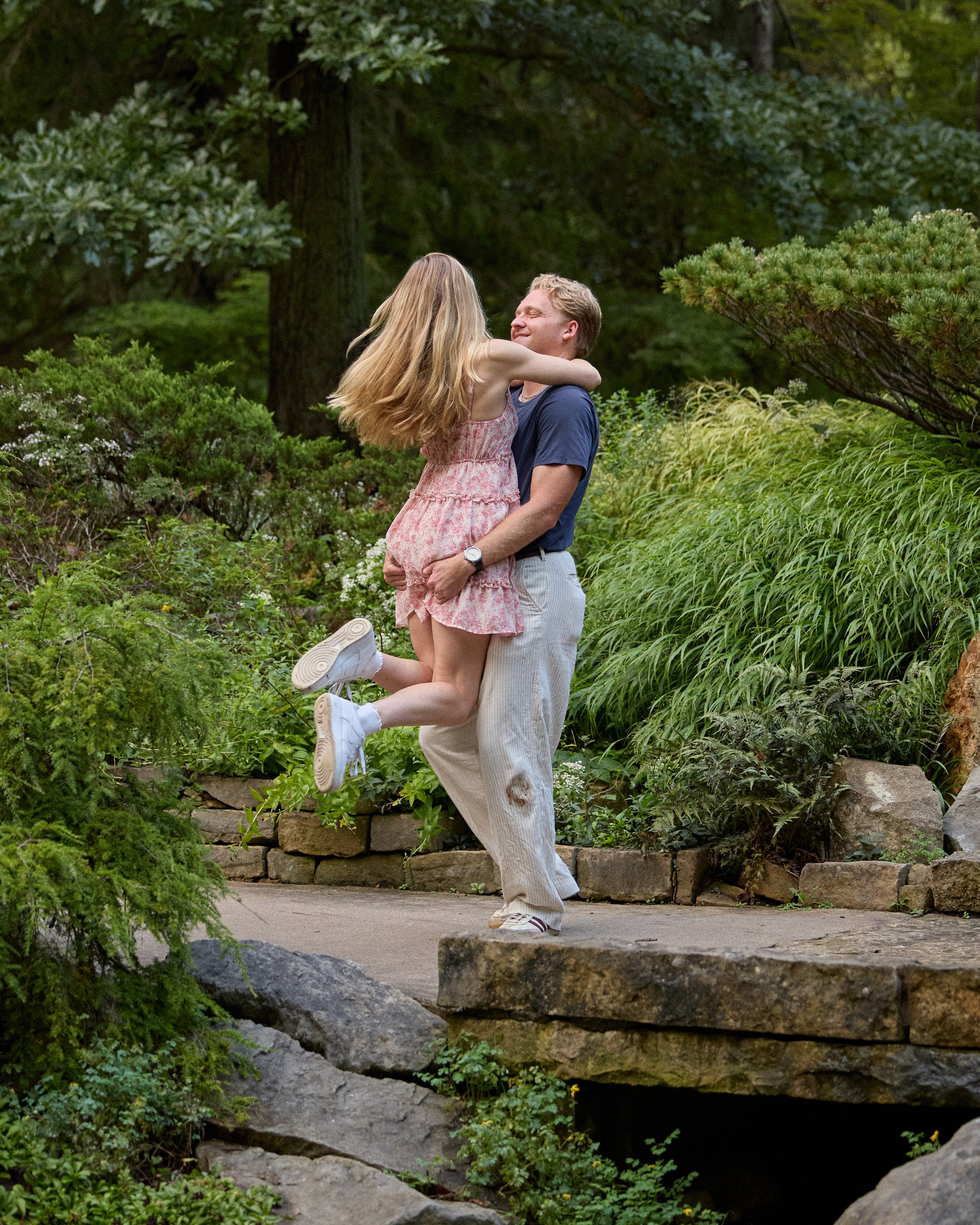 Groom lifting his fiancée on a stone bridge at Inniswood Metro Gardens, Ohio