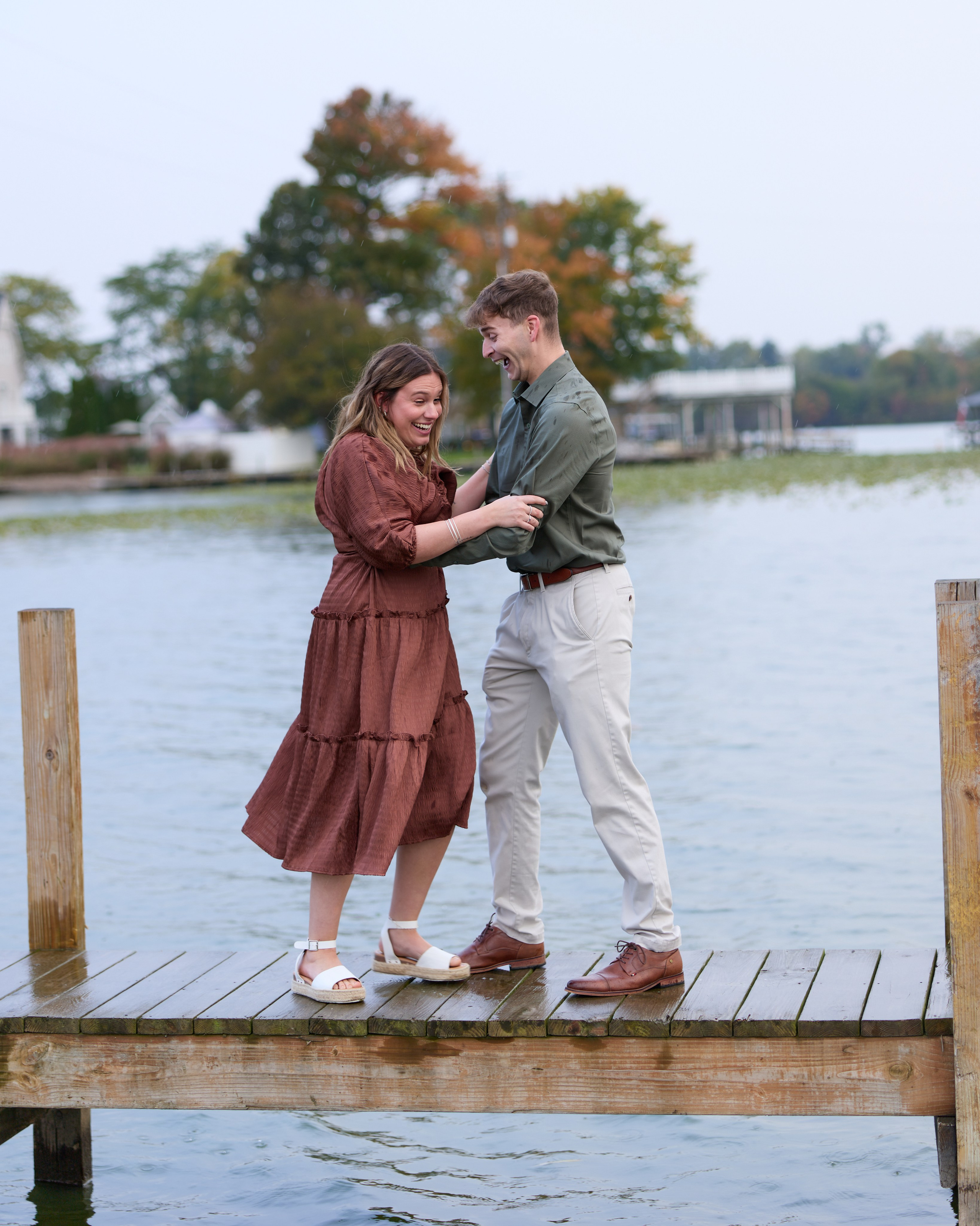 Couple embracing on the dock right after she said yes at Buckeye Lake, Ohio