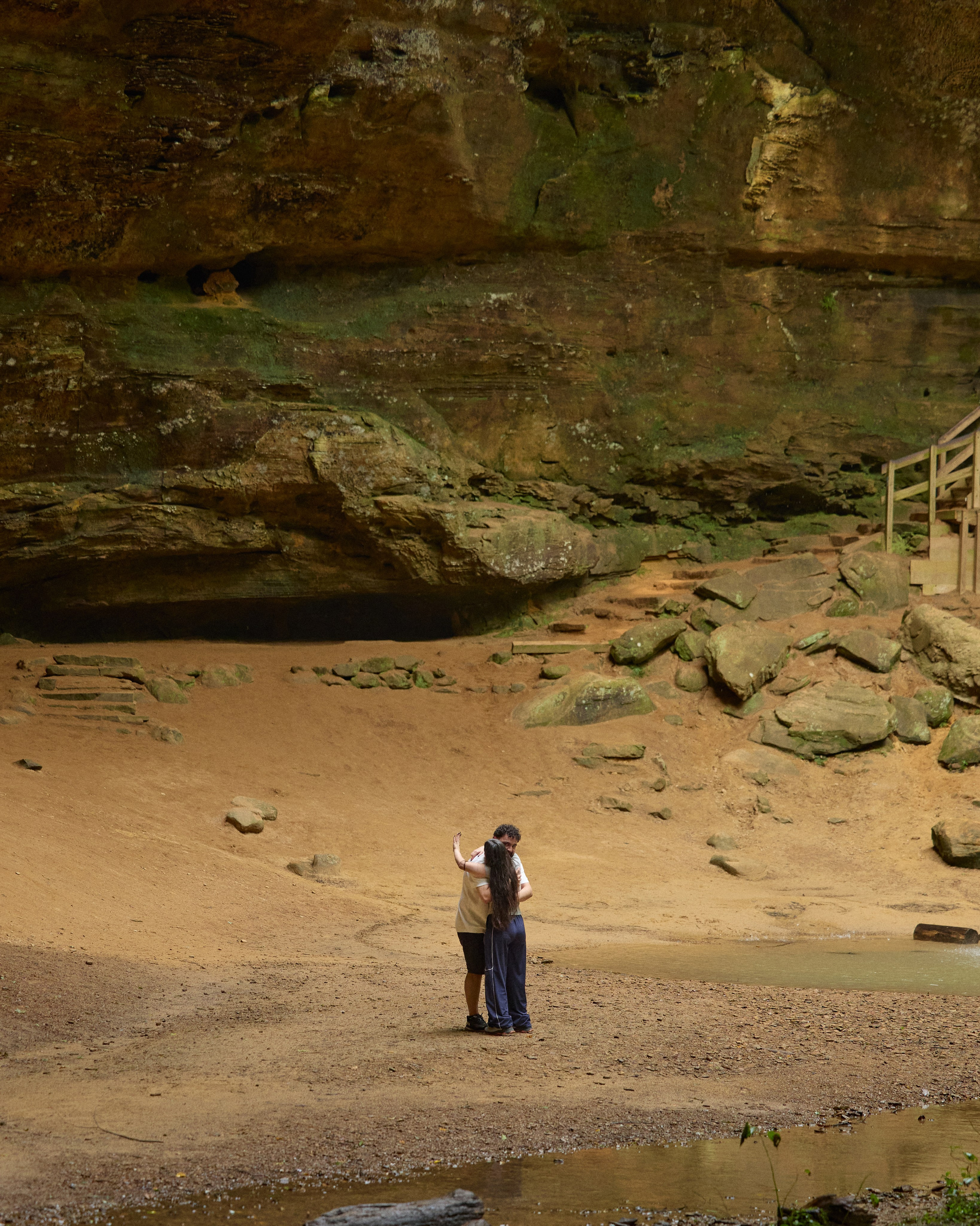 Tiny couple in a vast rocky gorge during an adventurous Ohio proposal