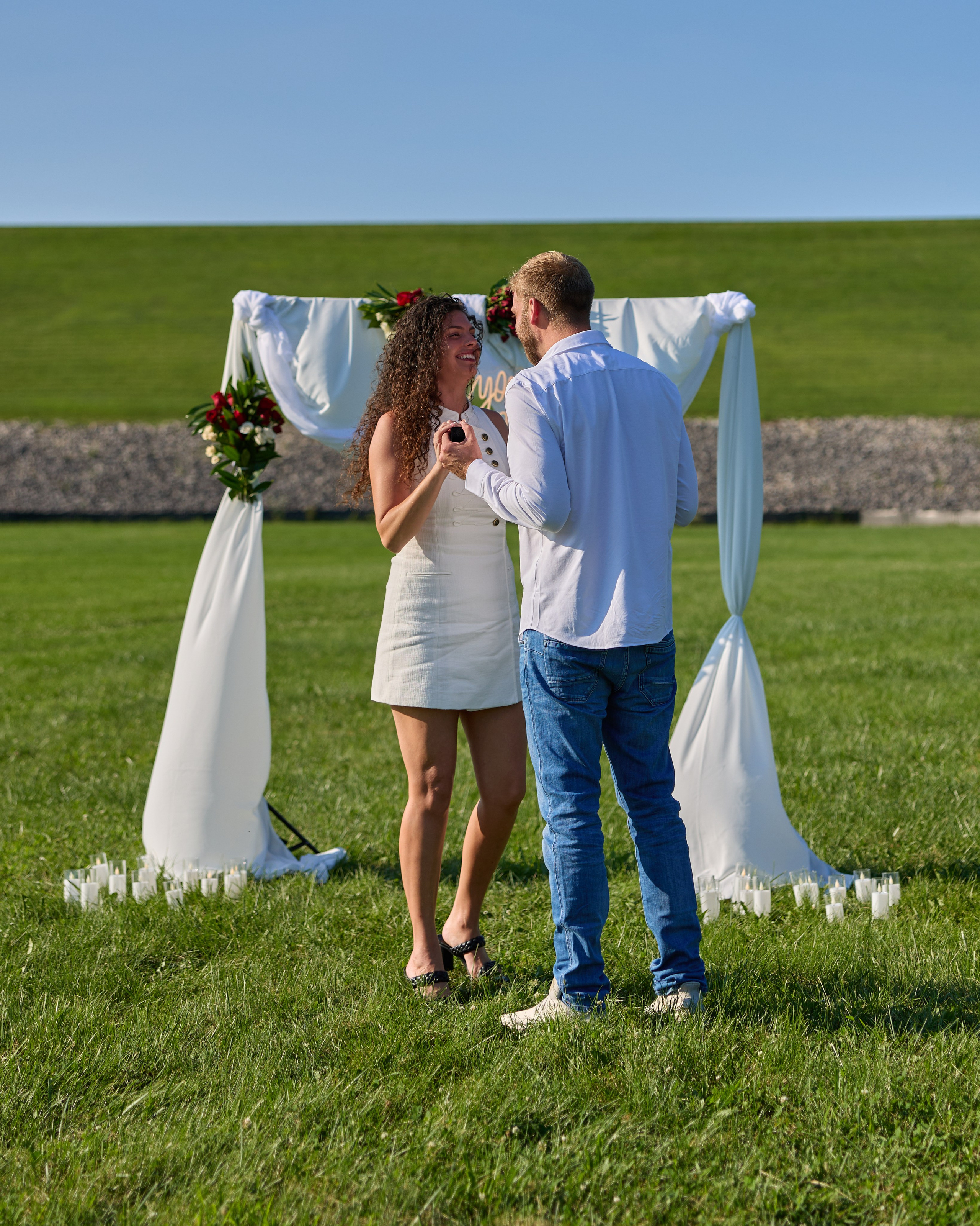 Newly engaged couple kissing under the arch at Alum Creek, Ohio