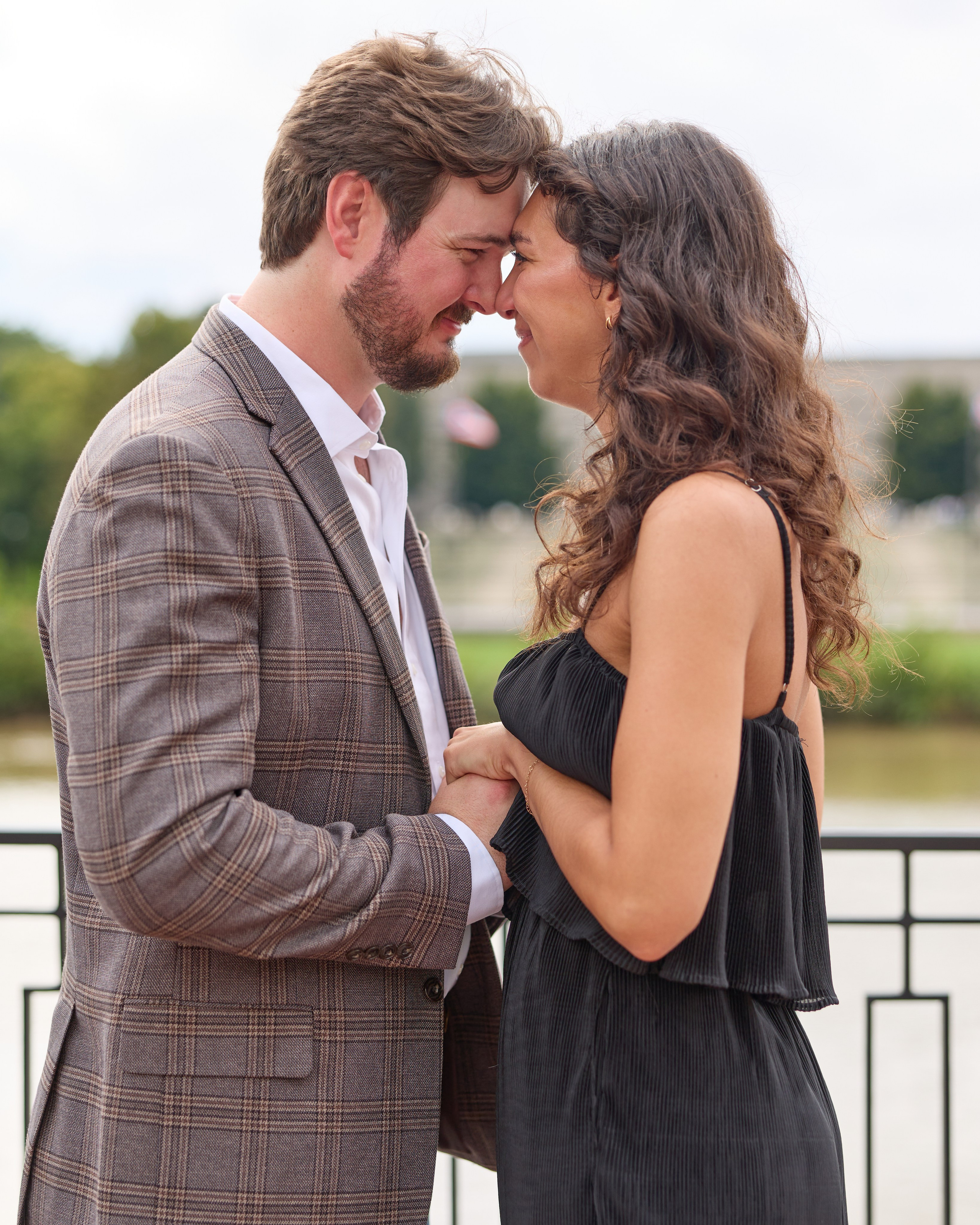 Engaged couple touching foreheads on a terrace in downtown Columbus, Ohio