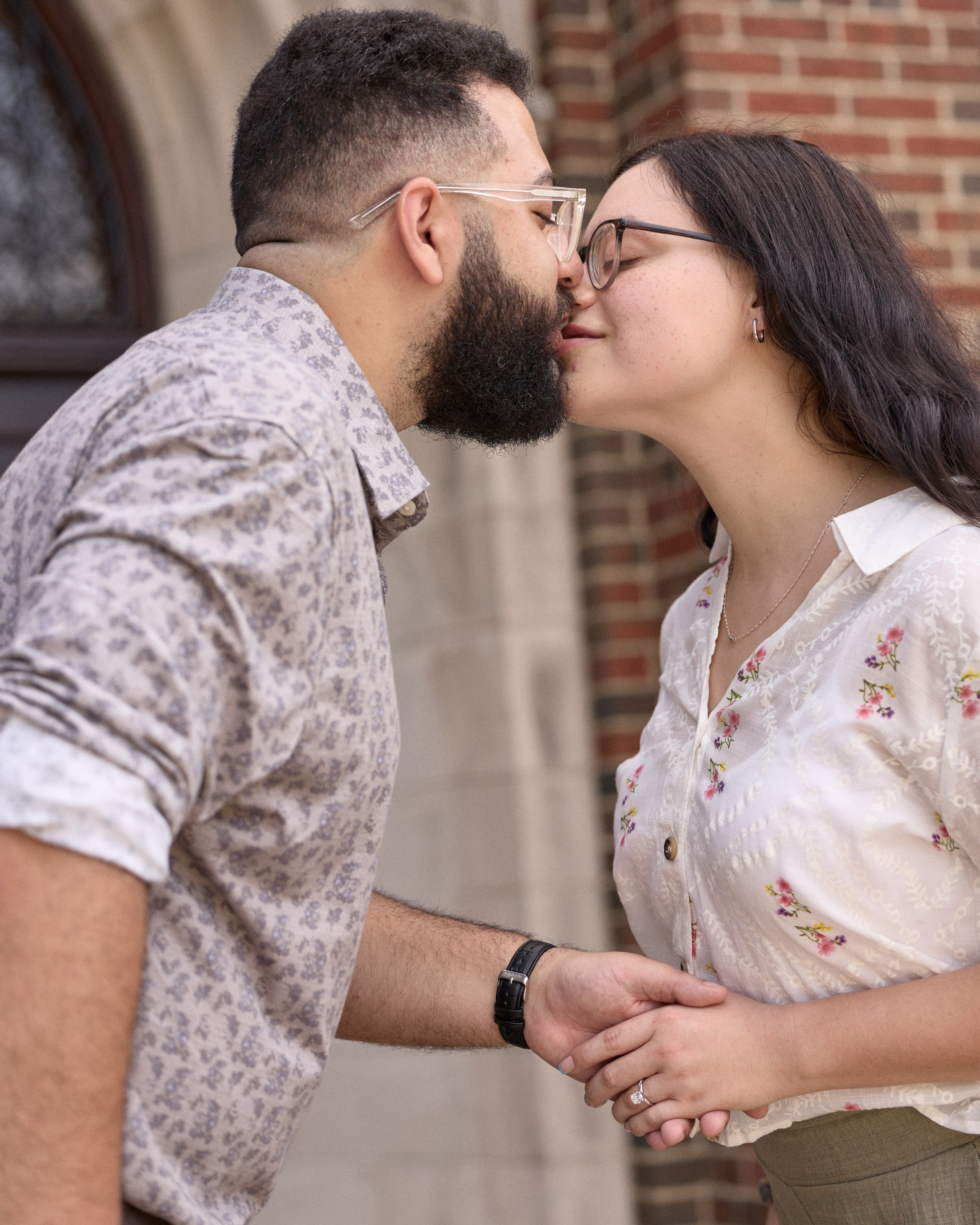 Romantic kiss by a brick archway at Capital University in Columbus, Ohio
