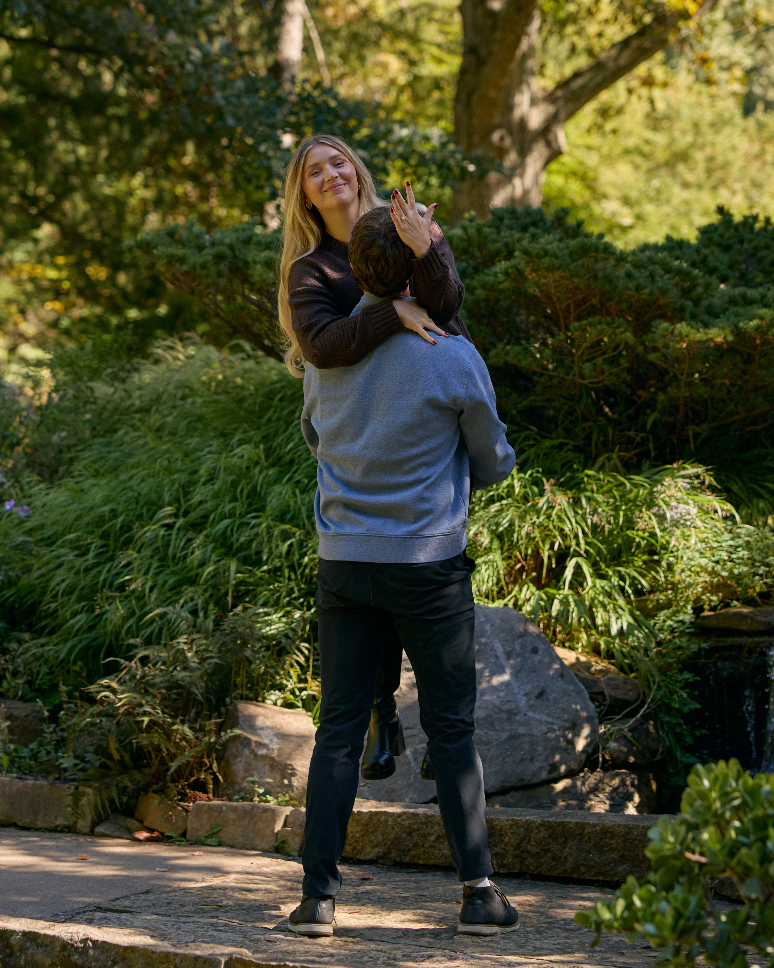 Close-up of intertwined hands after a proposal at Inniswood Metro Gardens, Ohio