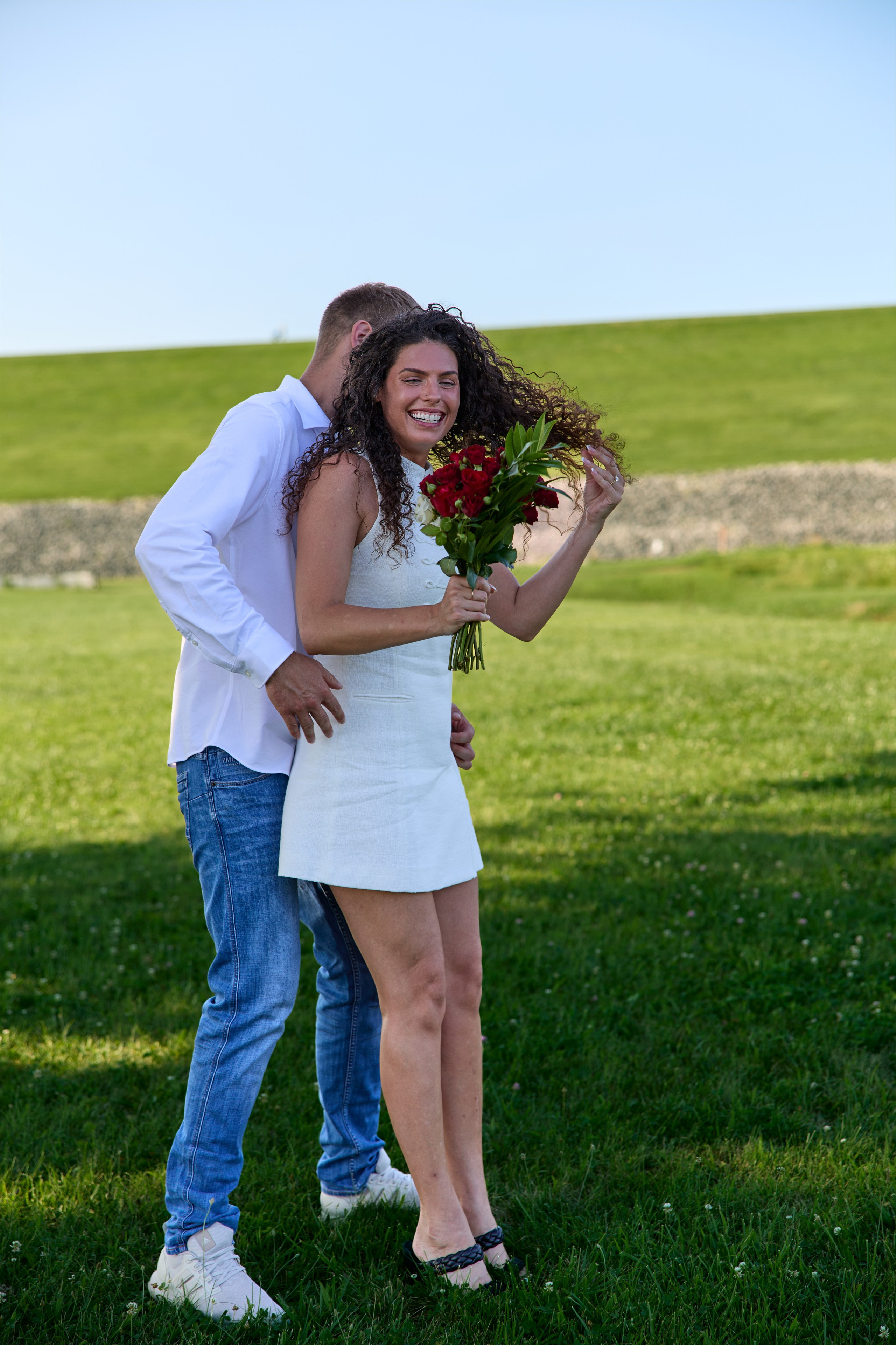 Couple embracing with a bouquet in the field at Alum Creek, Ohio