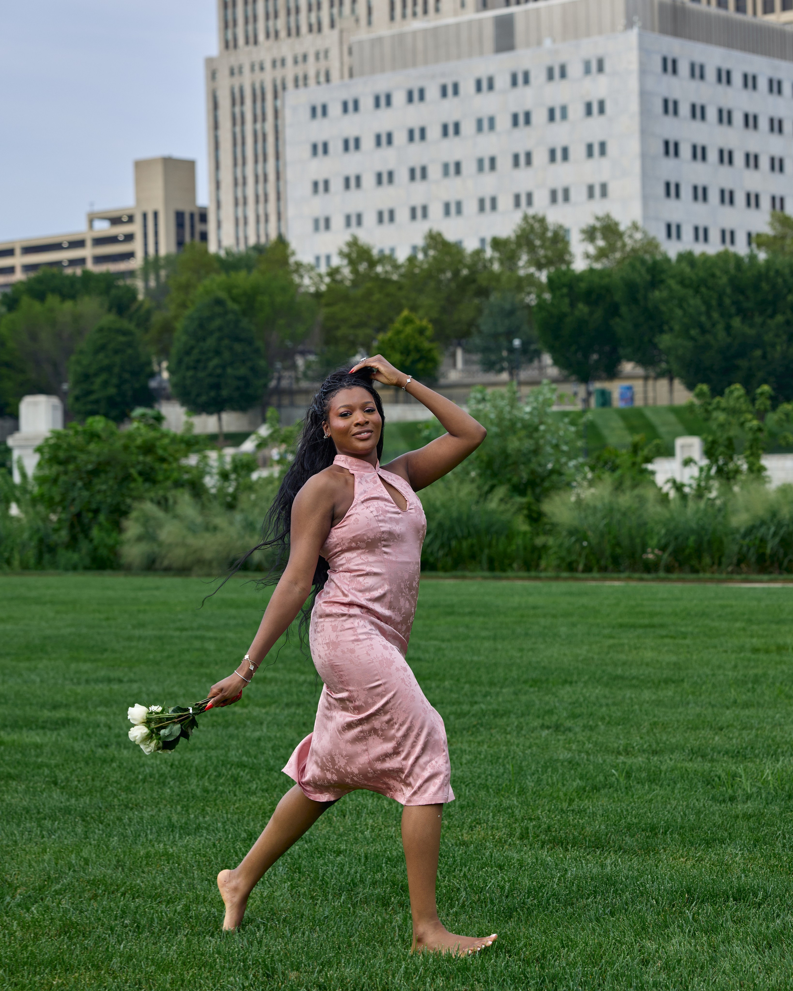 Bride-to-be twirling with her bouquet and the skyline behind in Columbus, Ohio