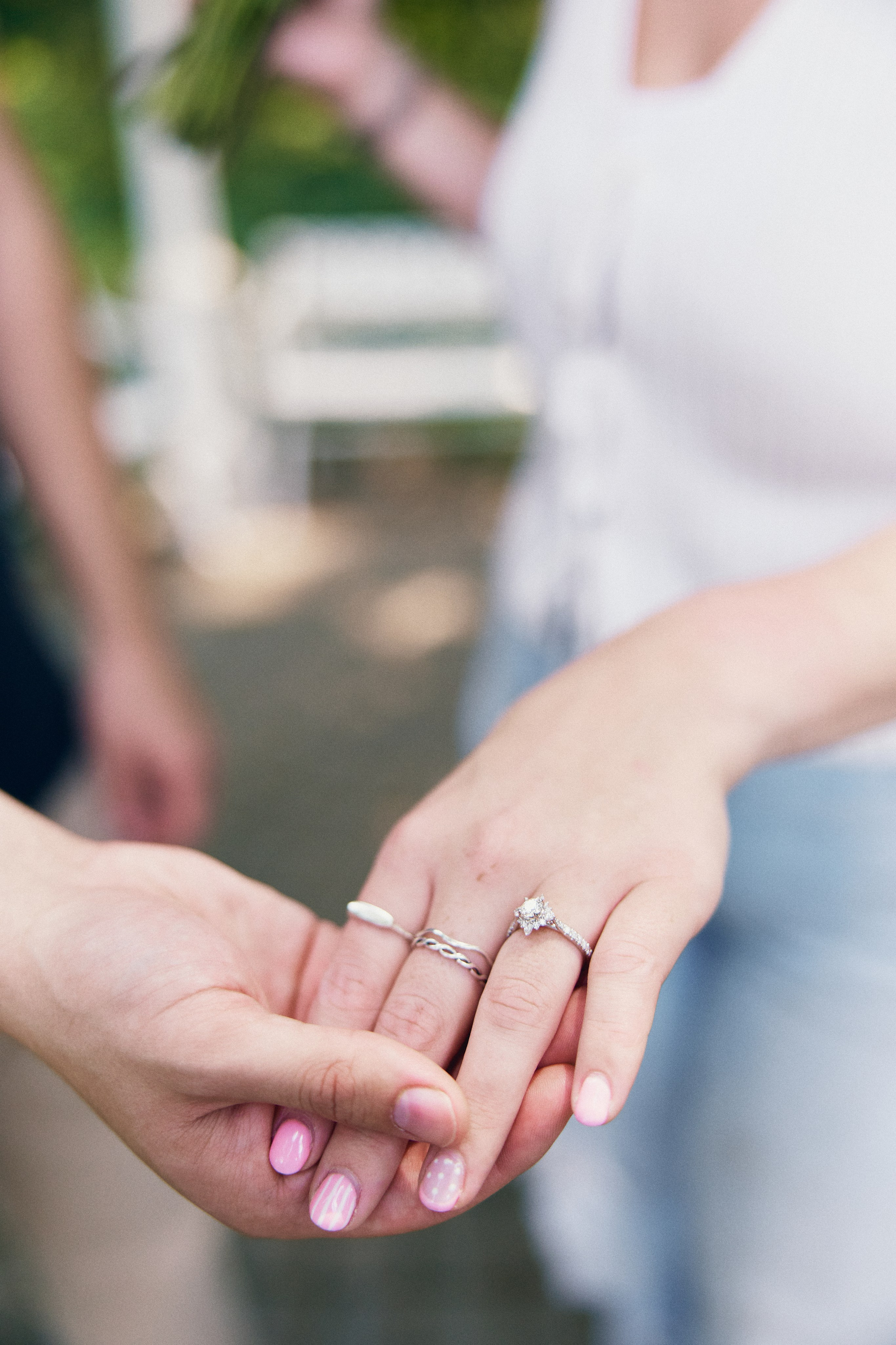 Close-up of hands with engagement and wedding bands at the Park of Roses in Columbus, Ohio