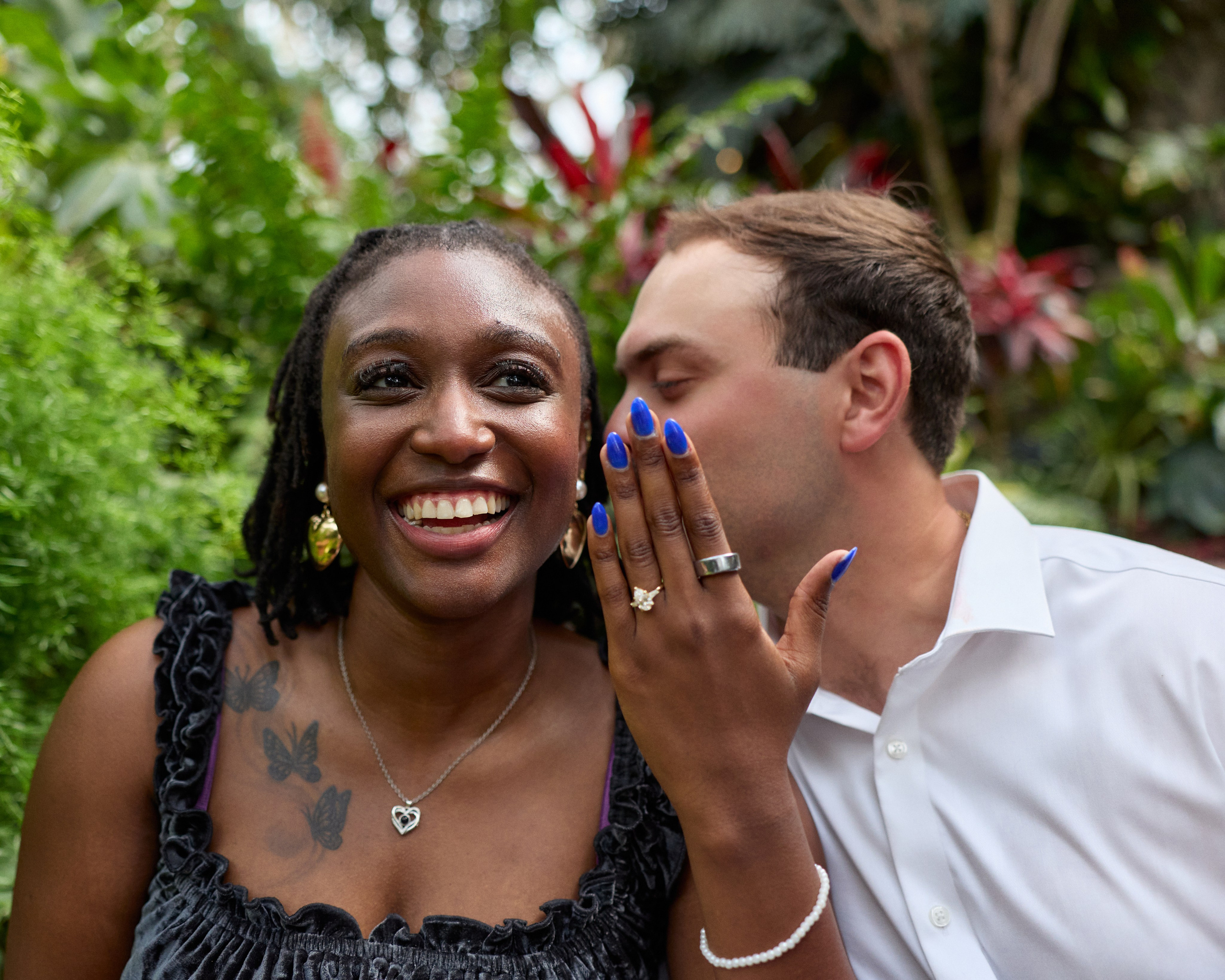 Close-up of a kiss on her cheek as she displays the ring at Franklin Park Conservatory in Columbus, Ohio