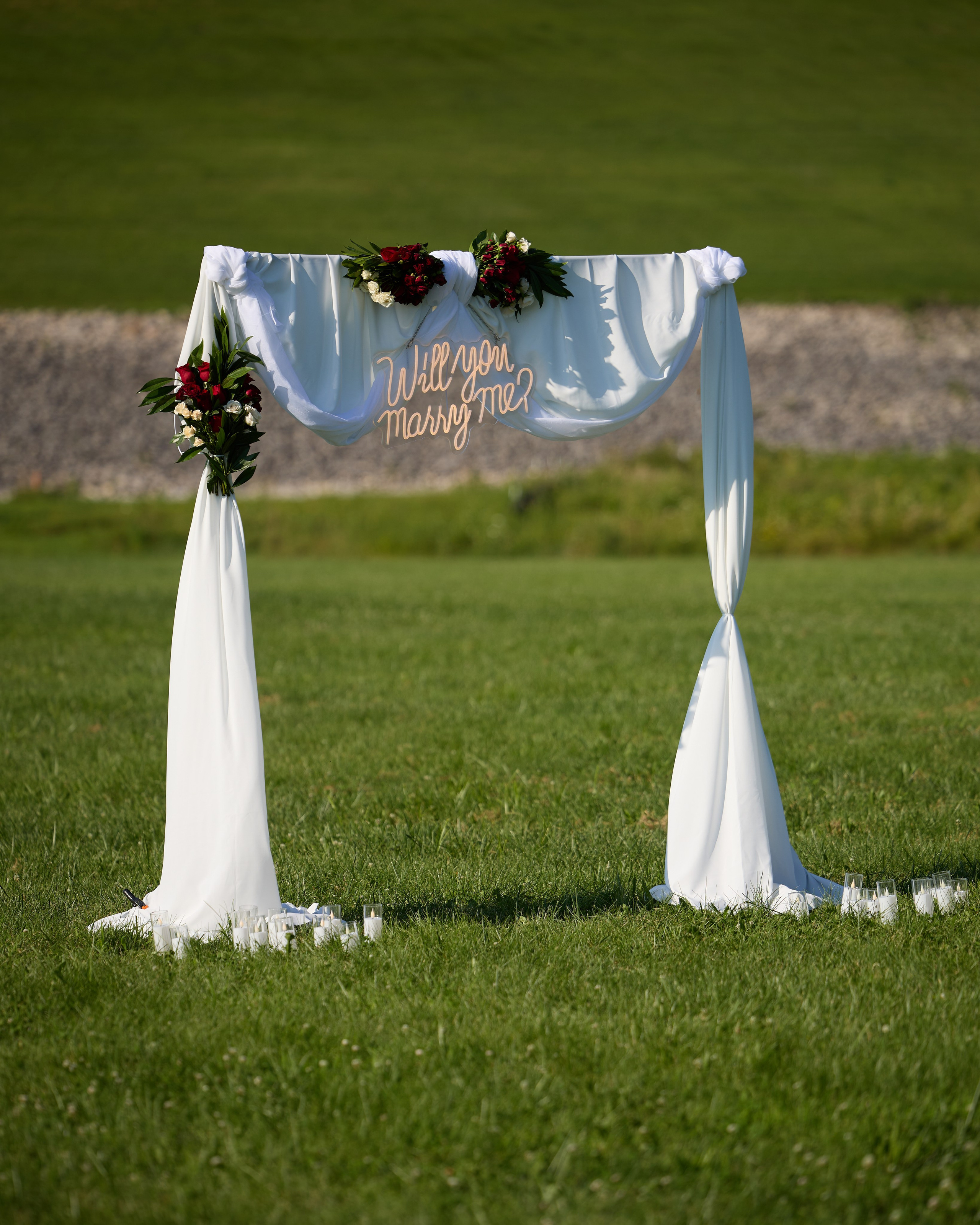 Wide setup shot of the decorated proposal arch in the field at Alum Creek, Ohio