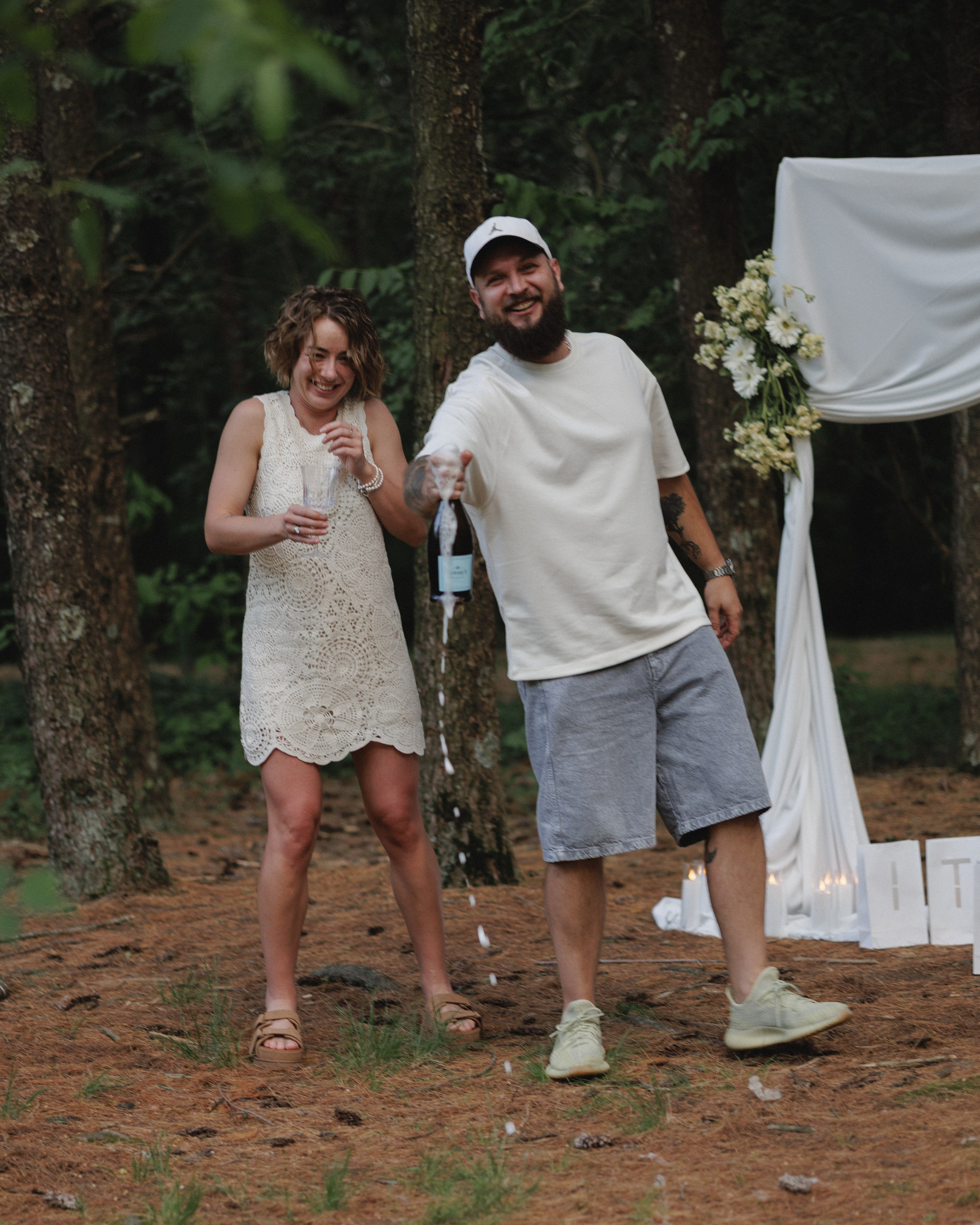 Newly engaged couple walking through the woods near Columbus, Ohio