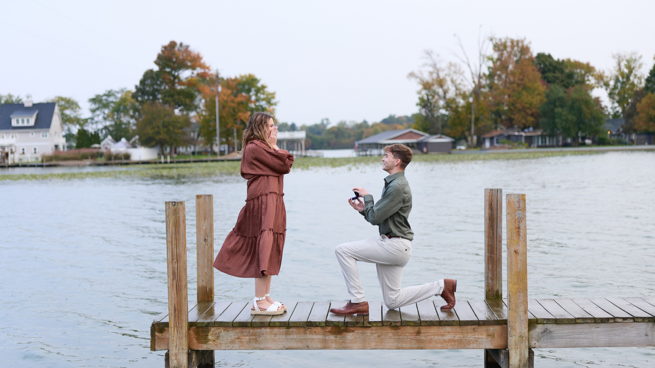 Side view of a lakeside proposal on a wooden dock in Ohio