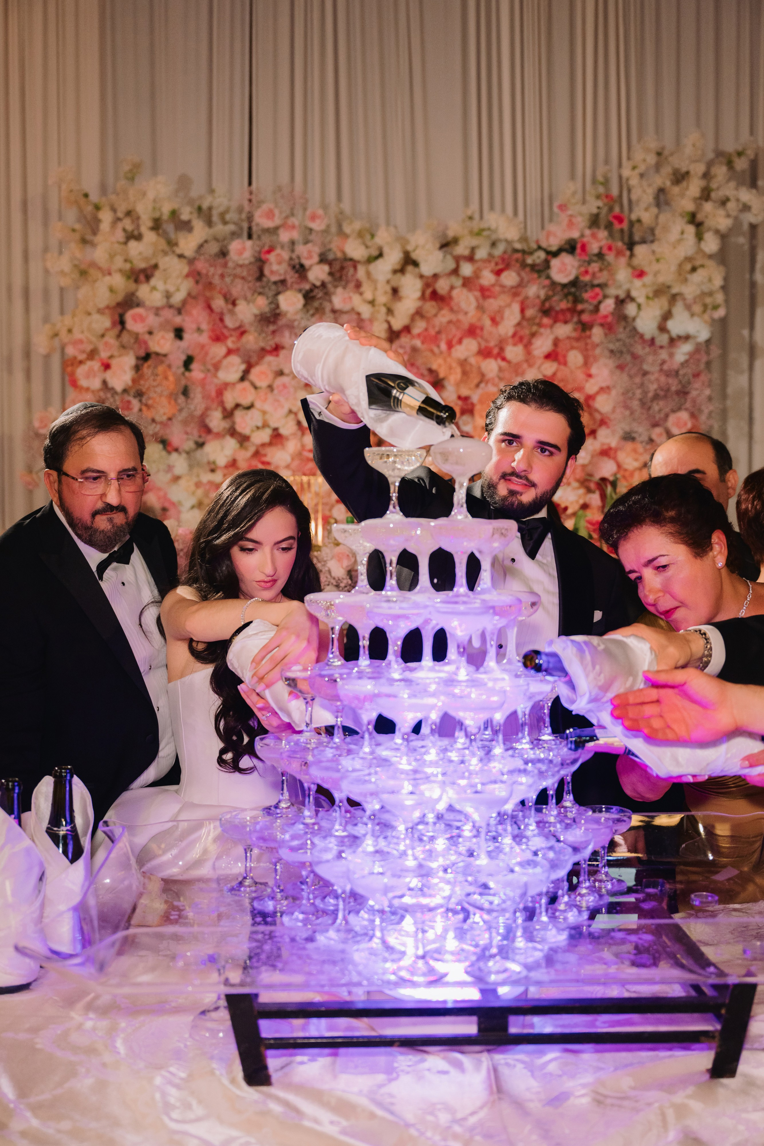 a group of people standing around a table