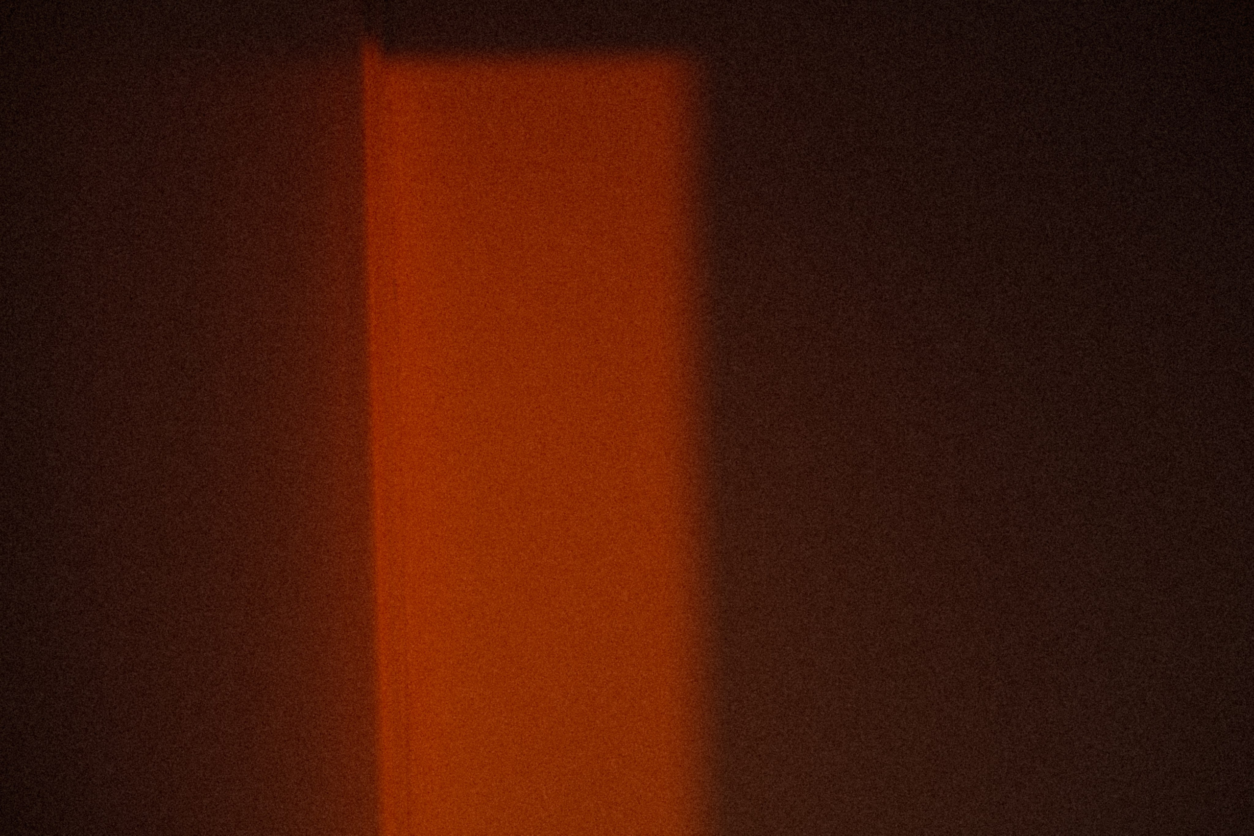 A warm-toned abstract image of a wall and shadow