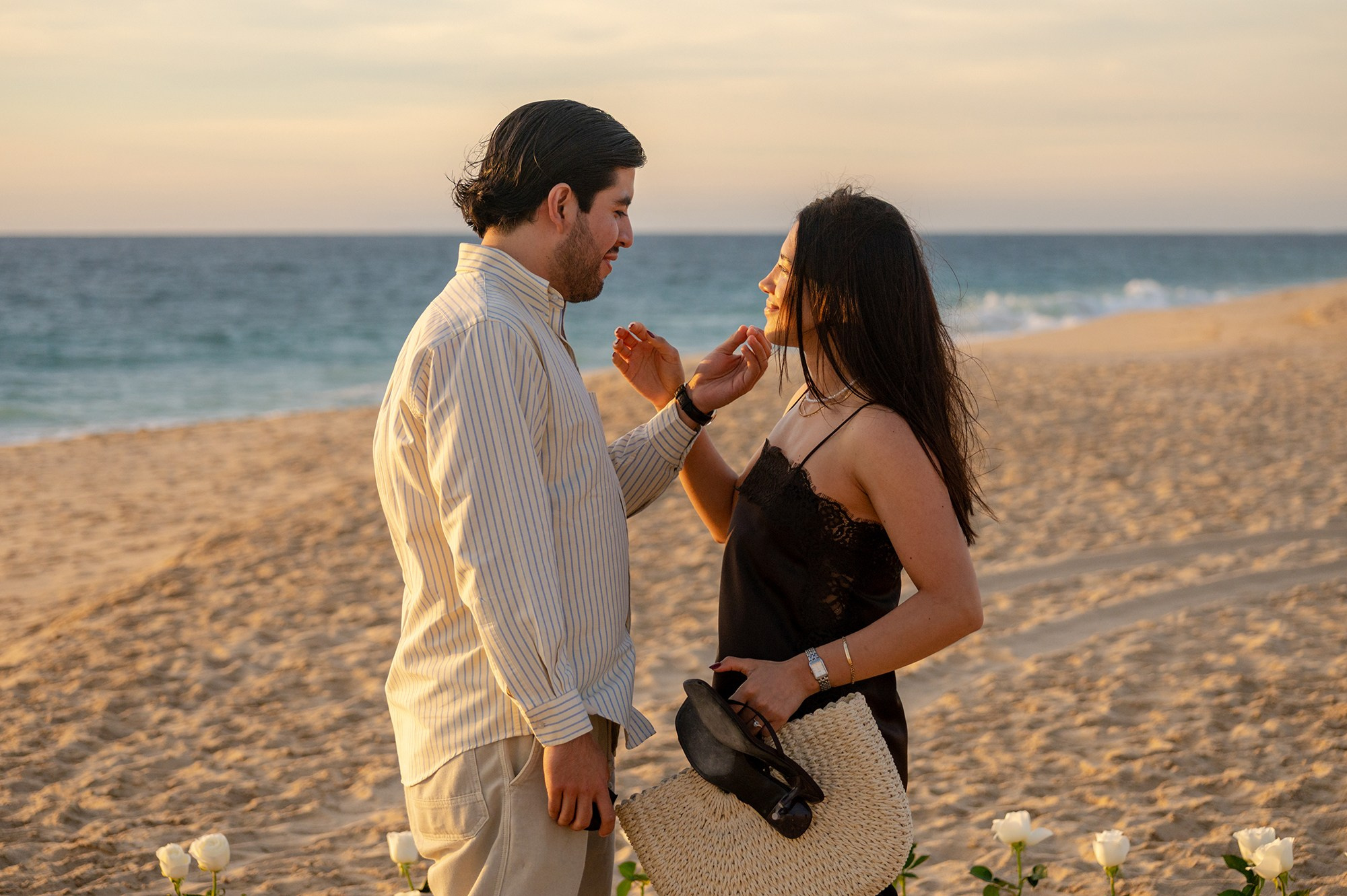 Couple kissing at sunset after beach proposal in Los Cabos Mexico