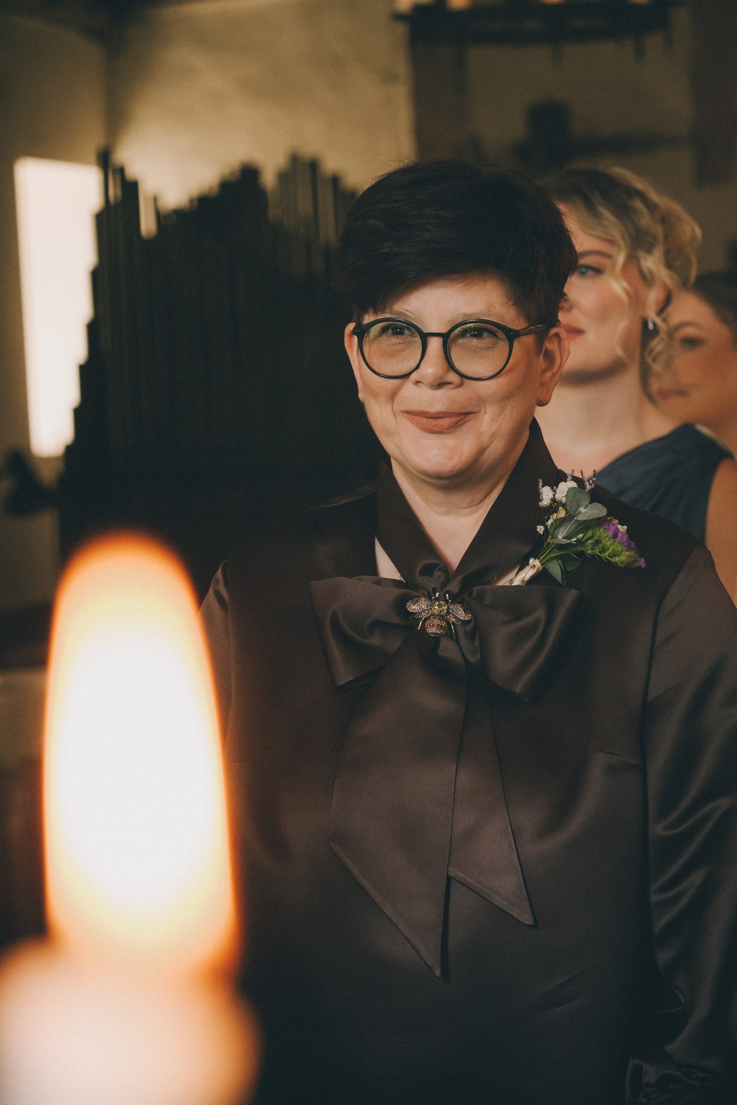 happy wedding ceremony with candles in small chapel