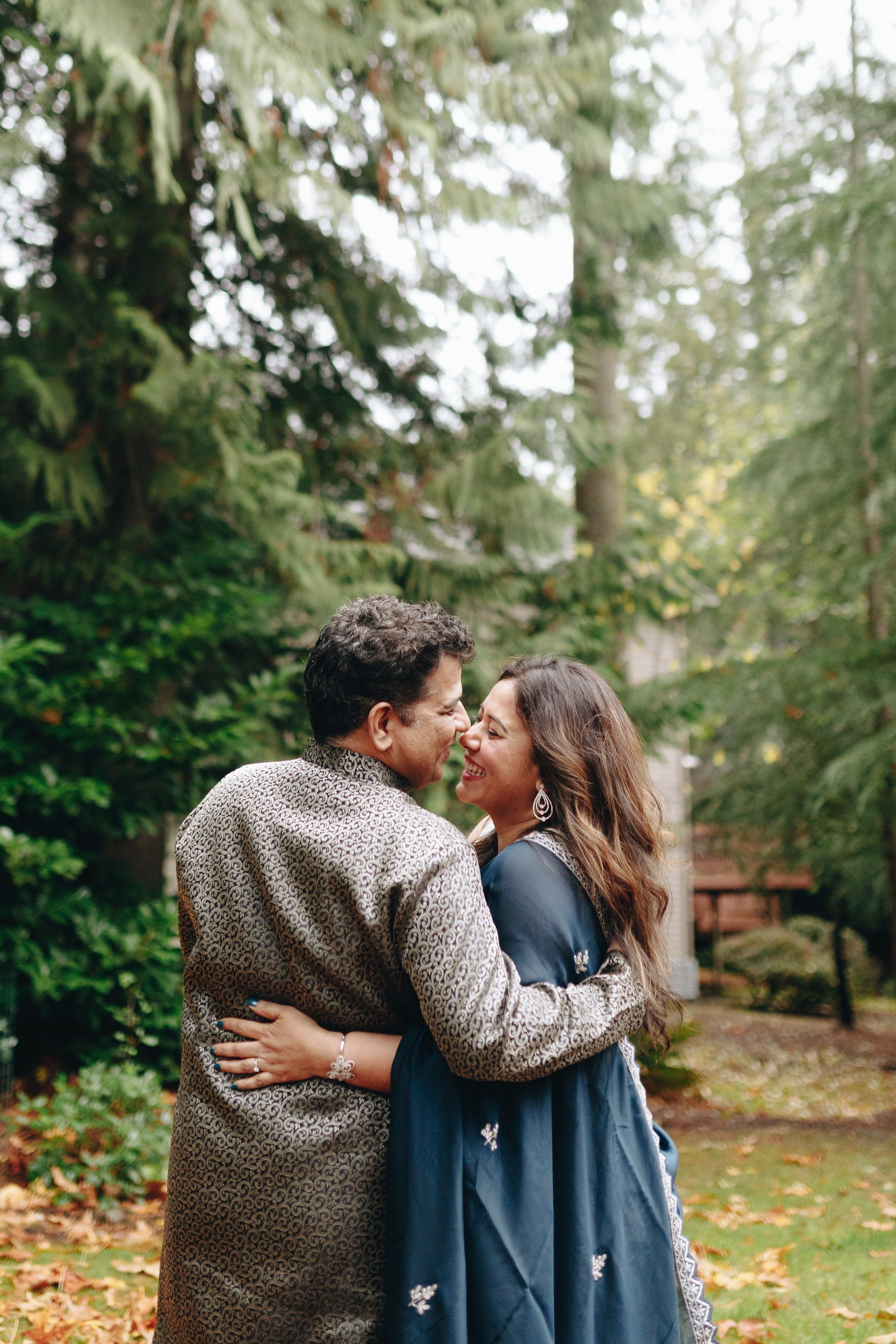 Couple standing together in forest, smiling