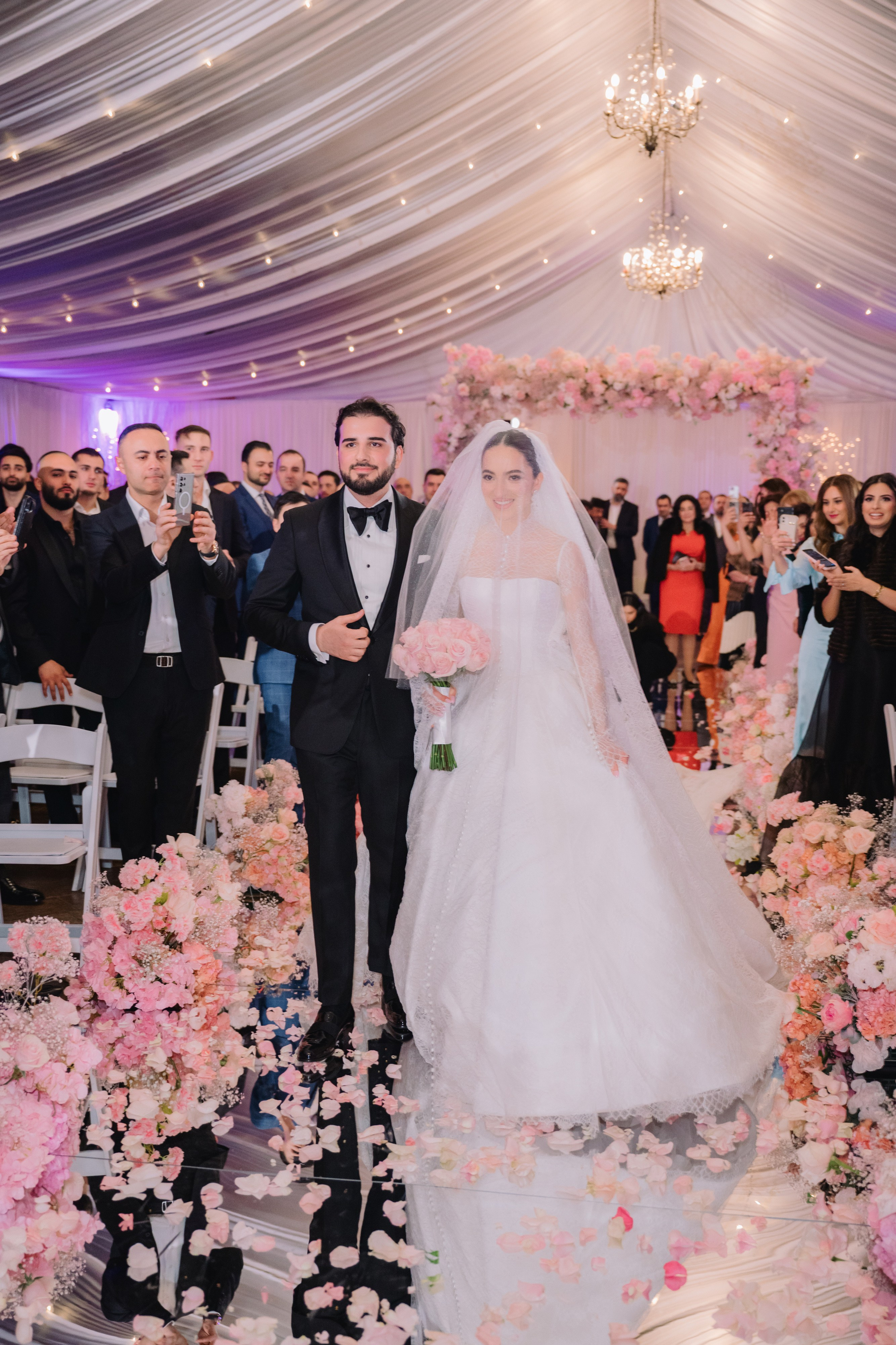 a bride and groom walking down the aisle