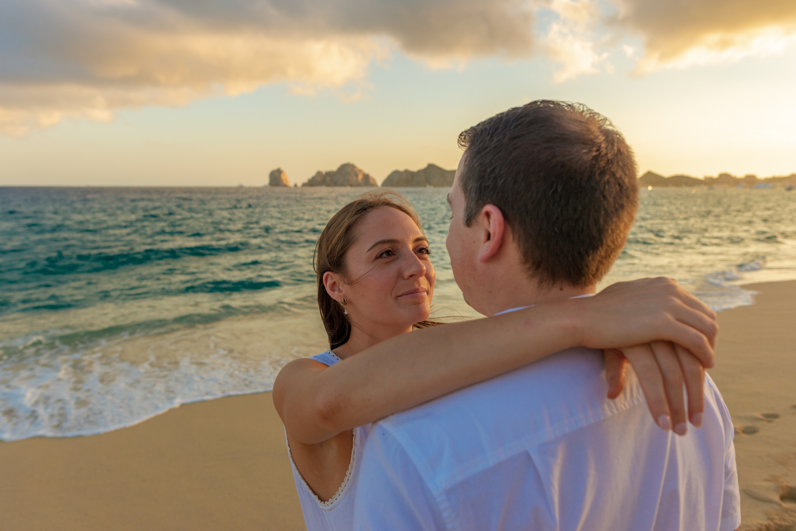 Couple during sunset photo session in Los Cabos before surprise proposal