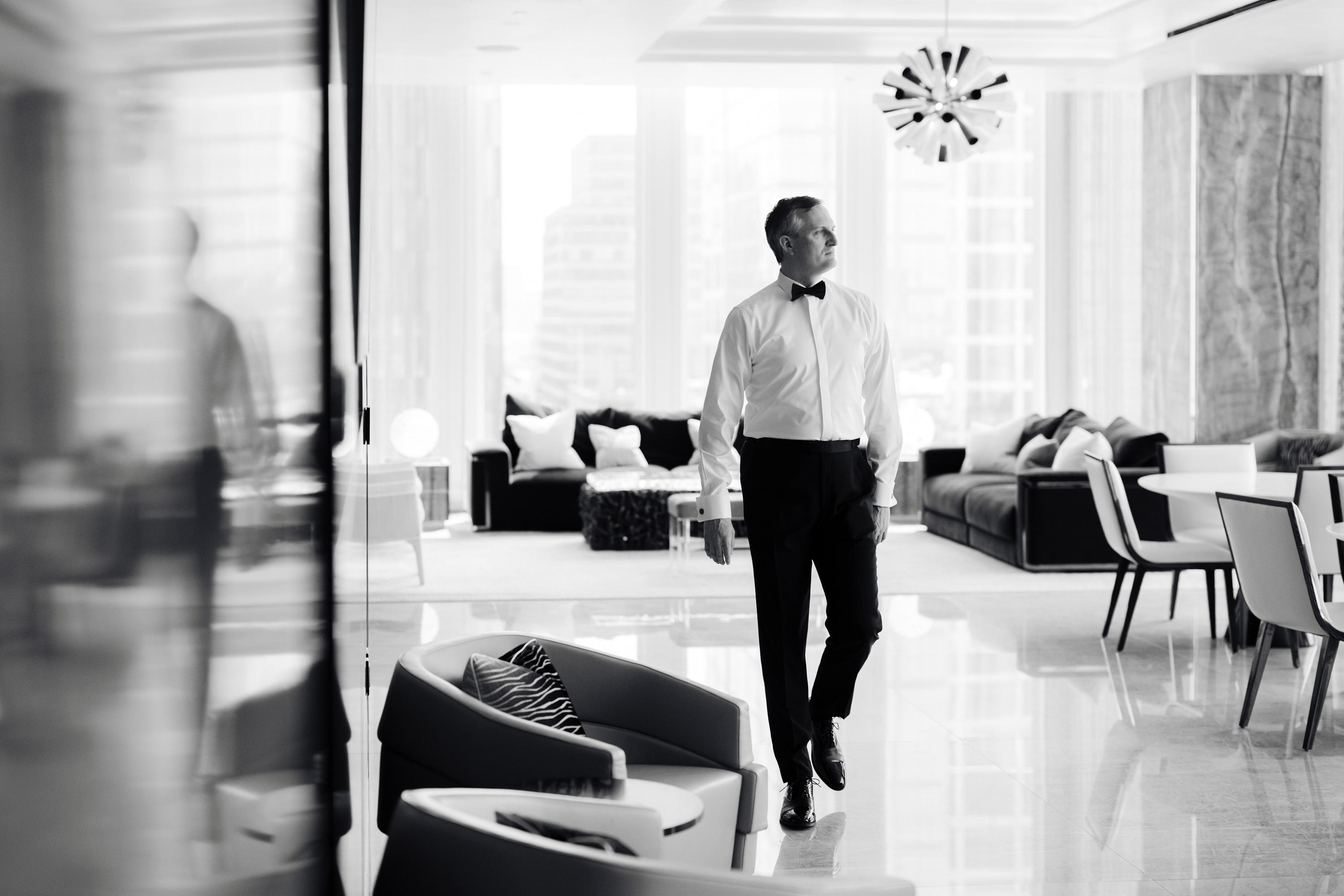 a man standing in a room with chairs
