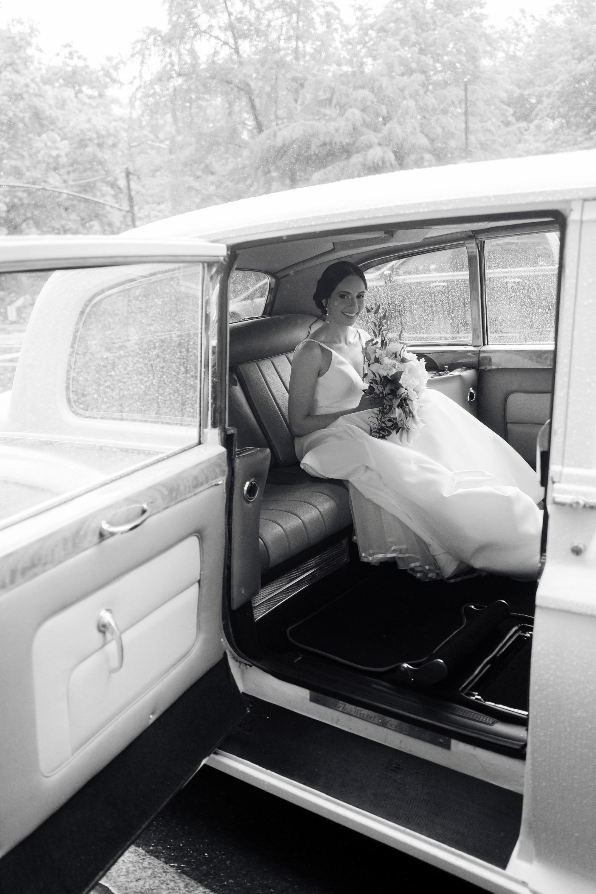 a bride getting out of a white car