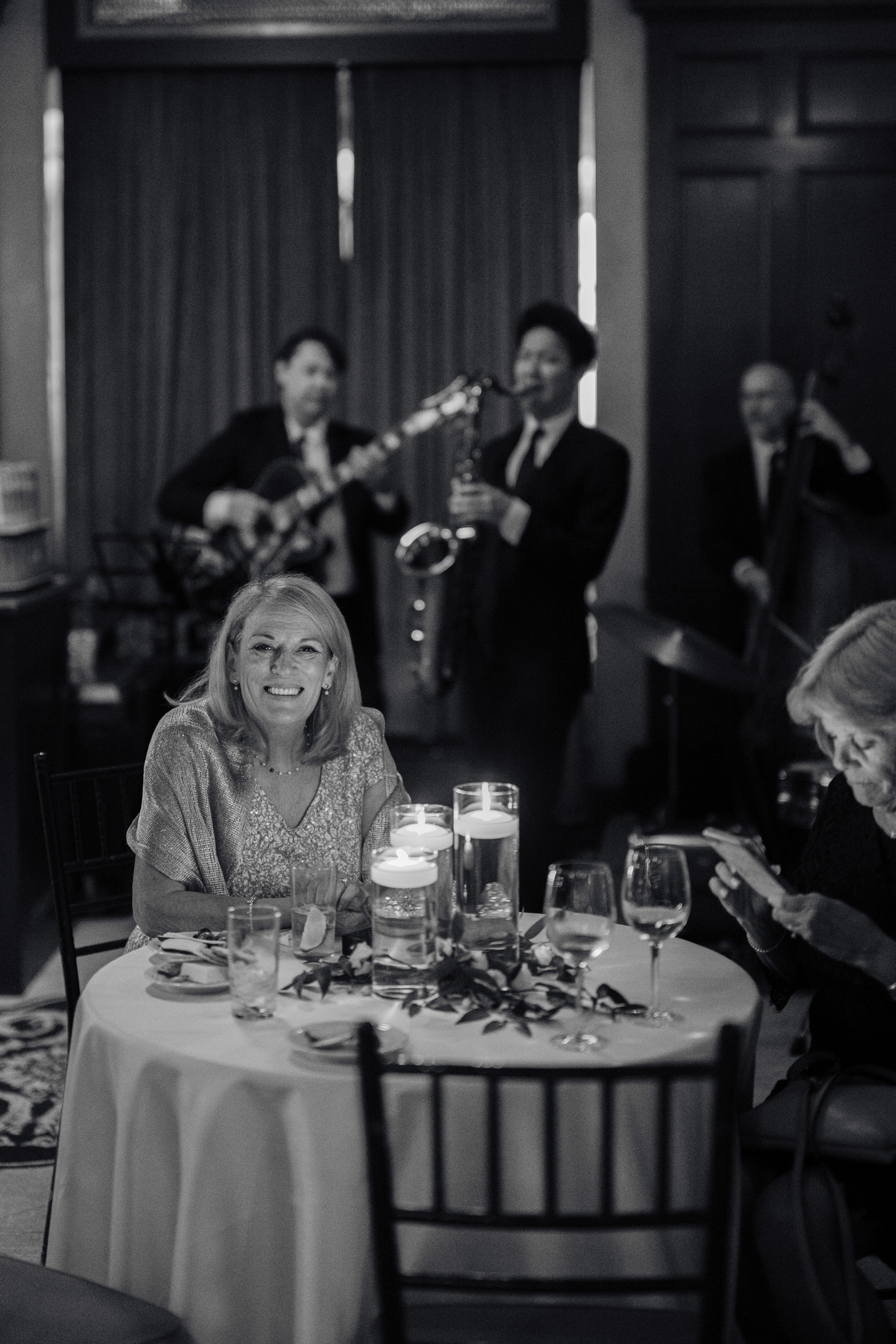 a woman sitting at a table with a candle