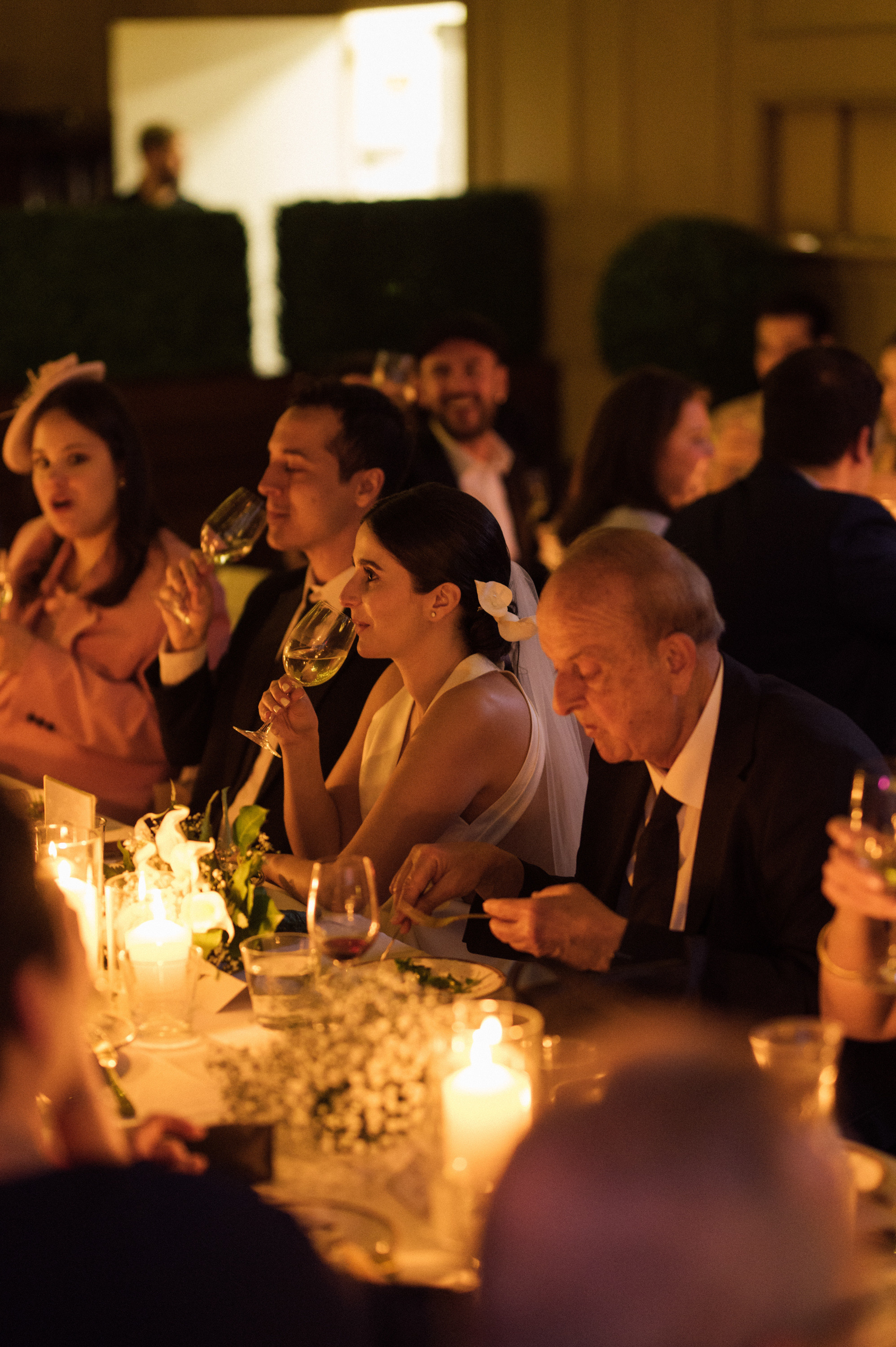 a group of people sitting at a table with wine glasses