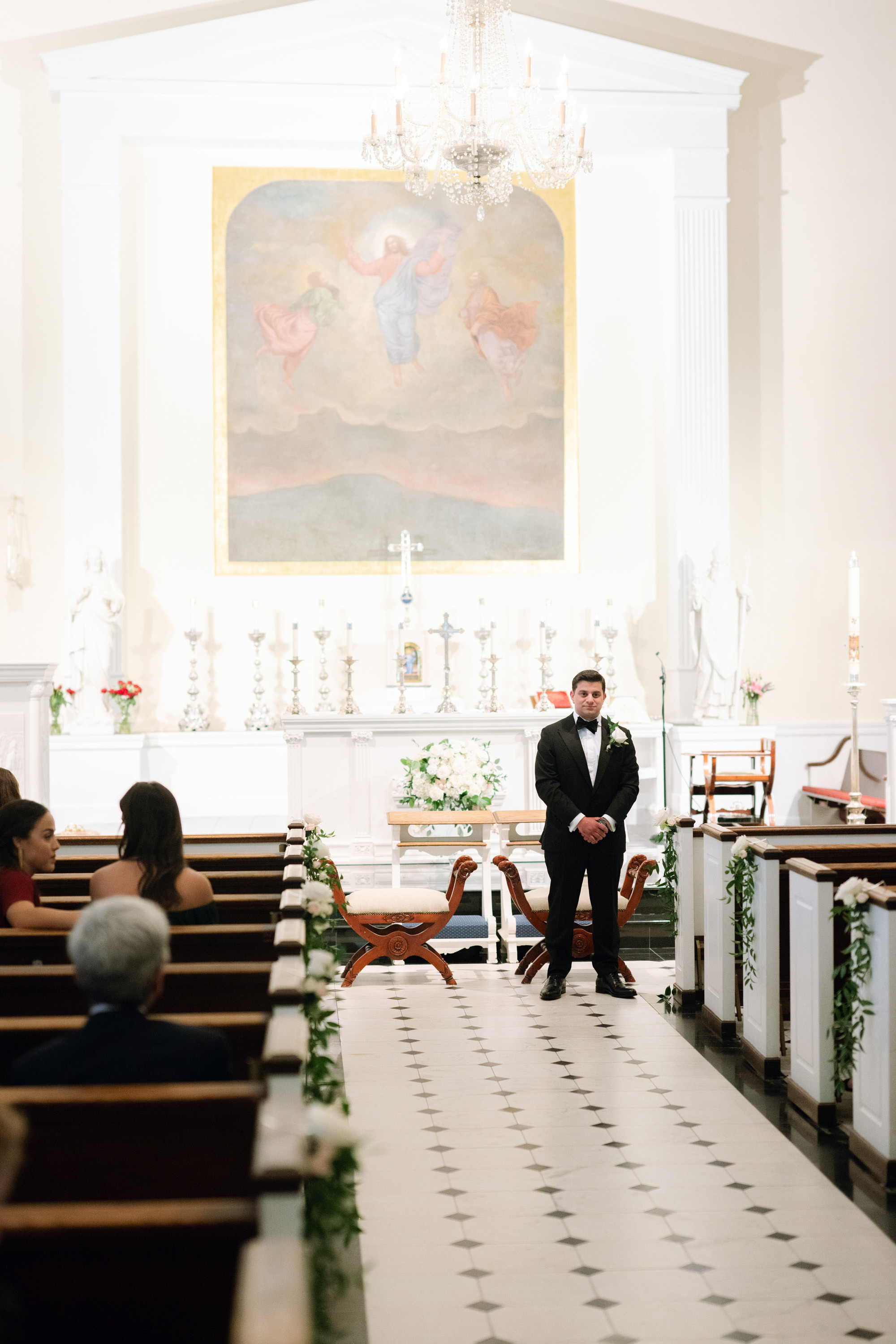 a man in a suit and tie standing in a church