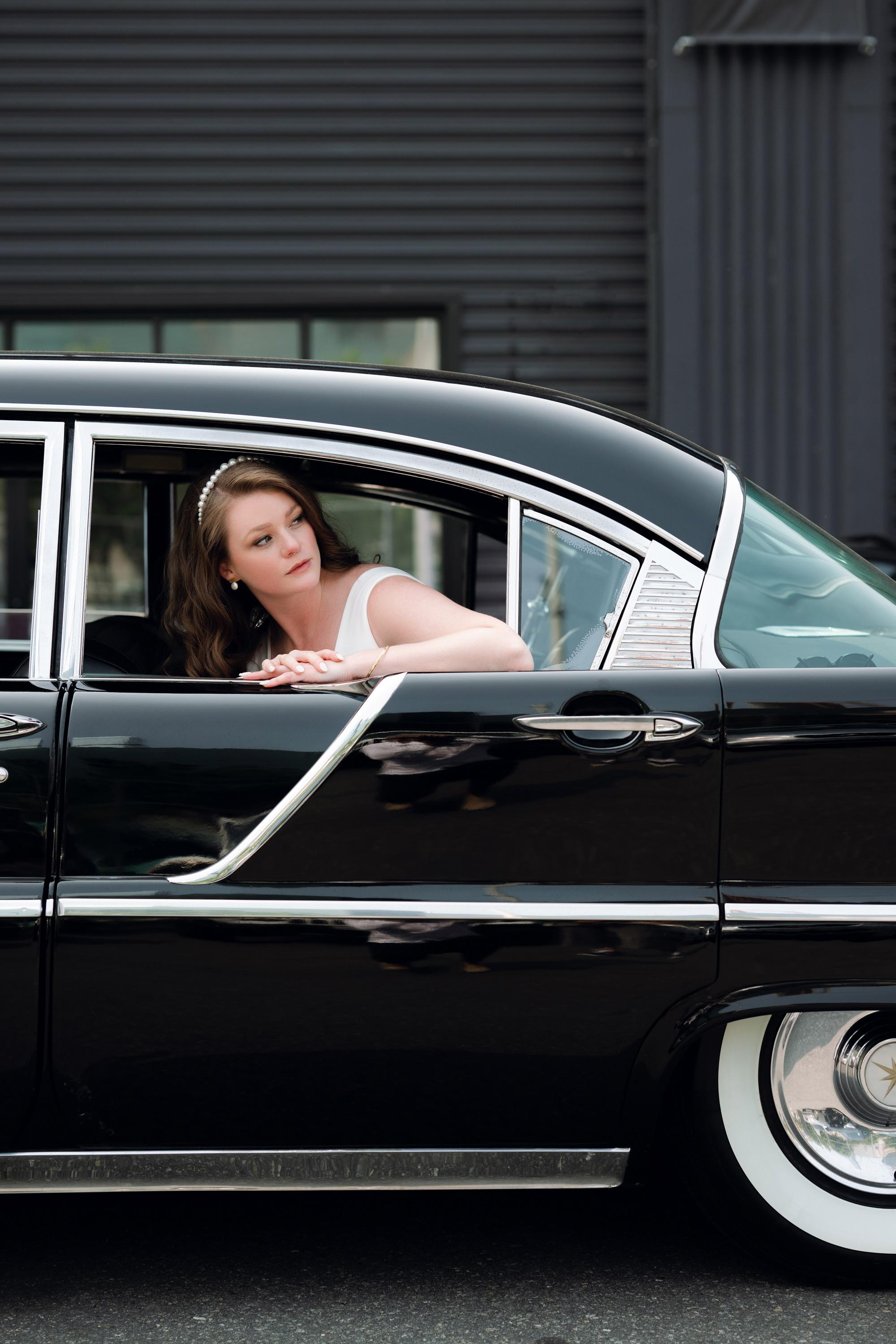 a woman sitting in a black car