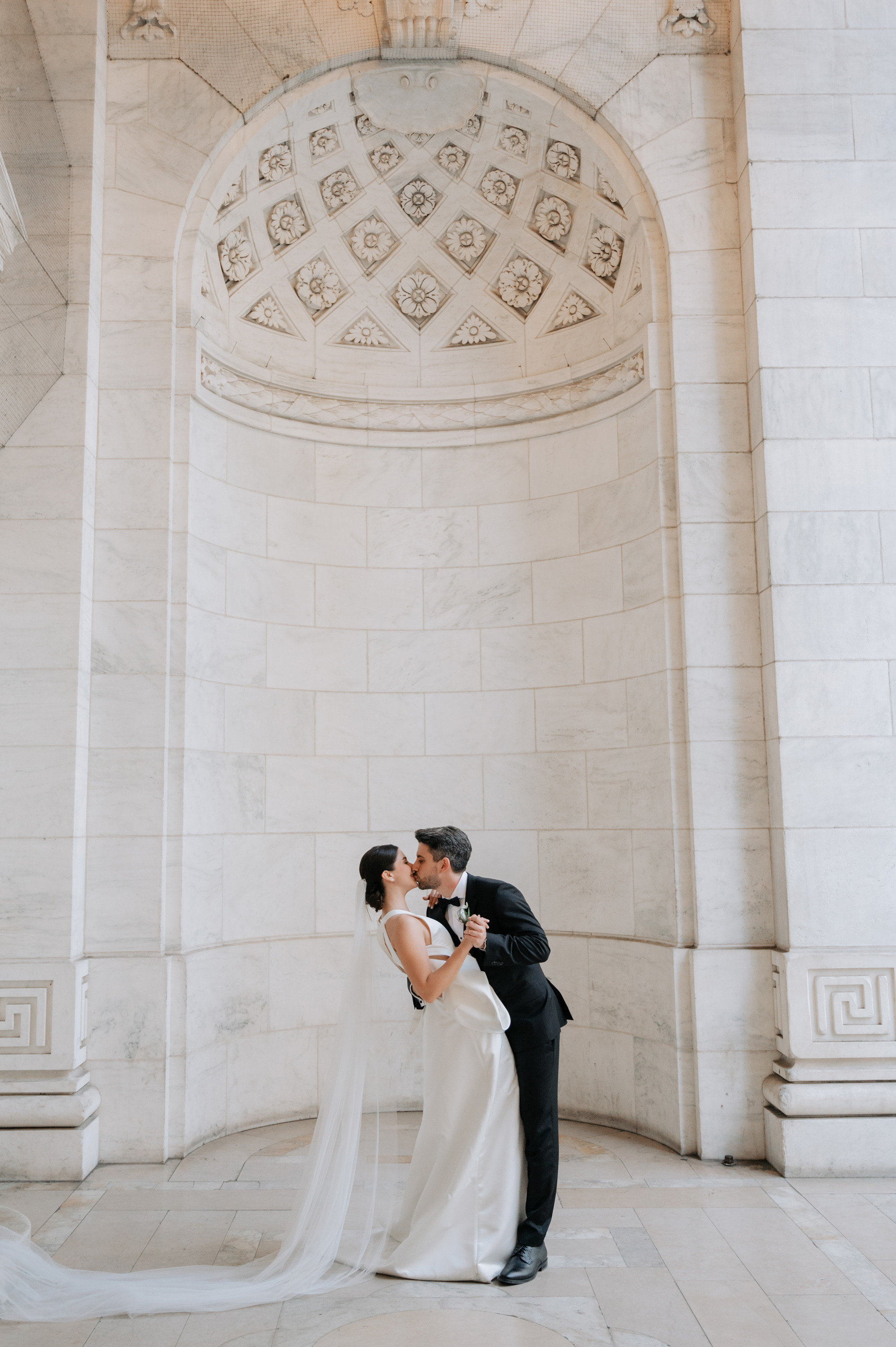 a bride and groom kissing in front of the washington memorial