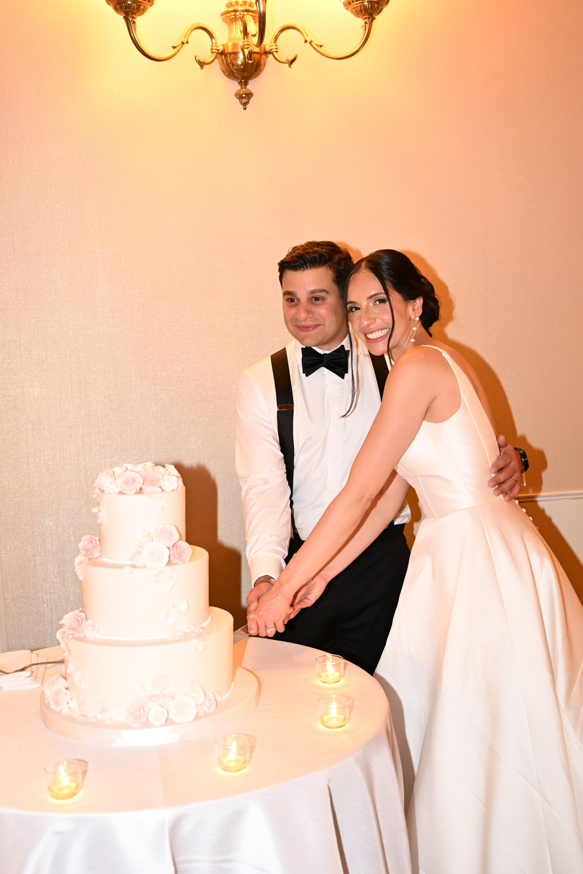 a bride and groom cutting a wedding cake
