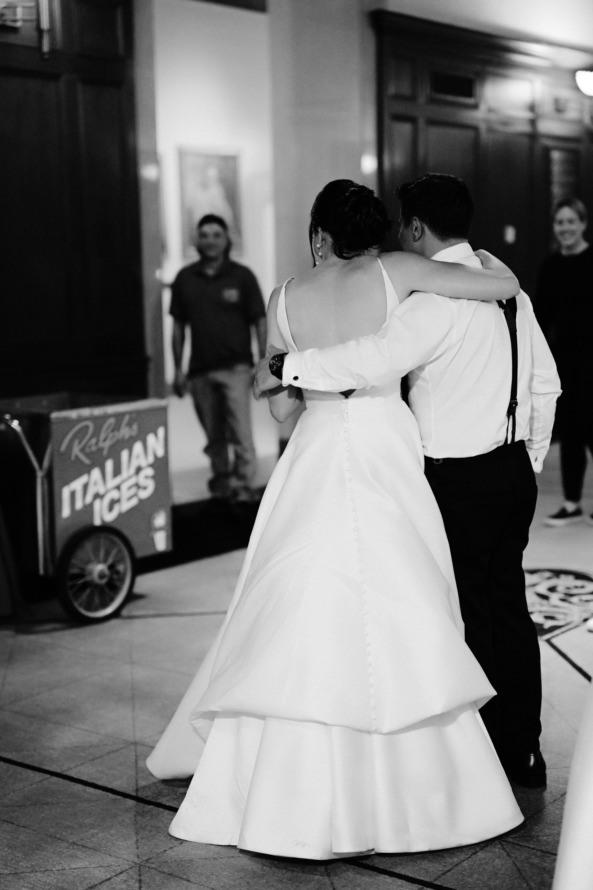 a bride and groom dance together in a lobby
