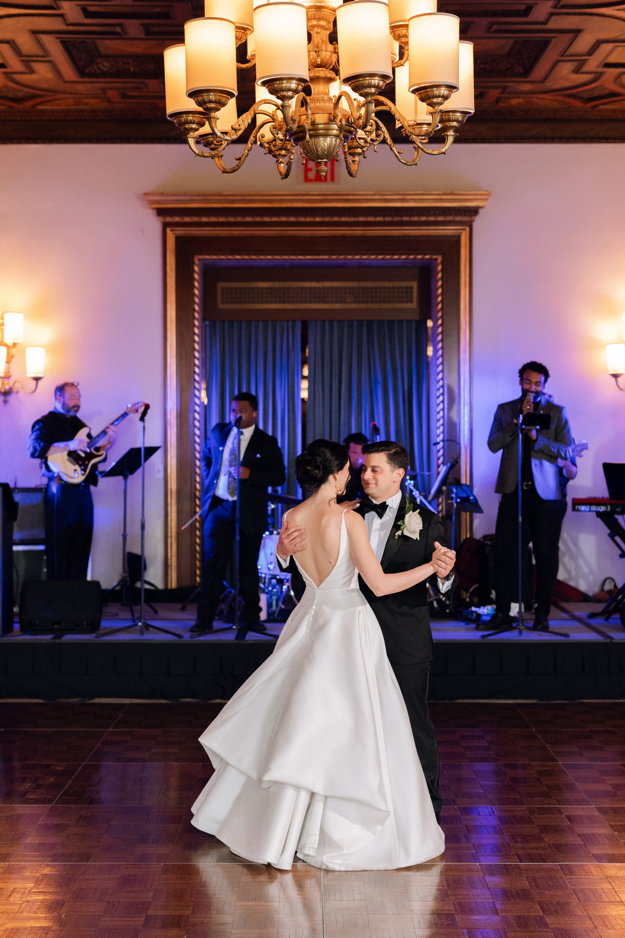 a bride and groom dance together at their wedding reception