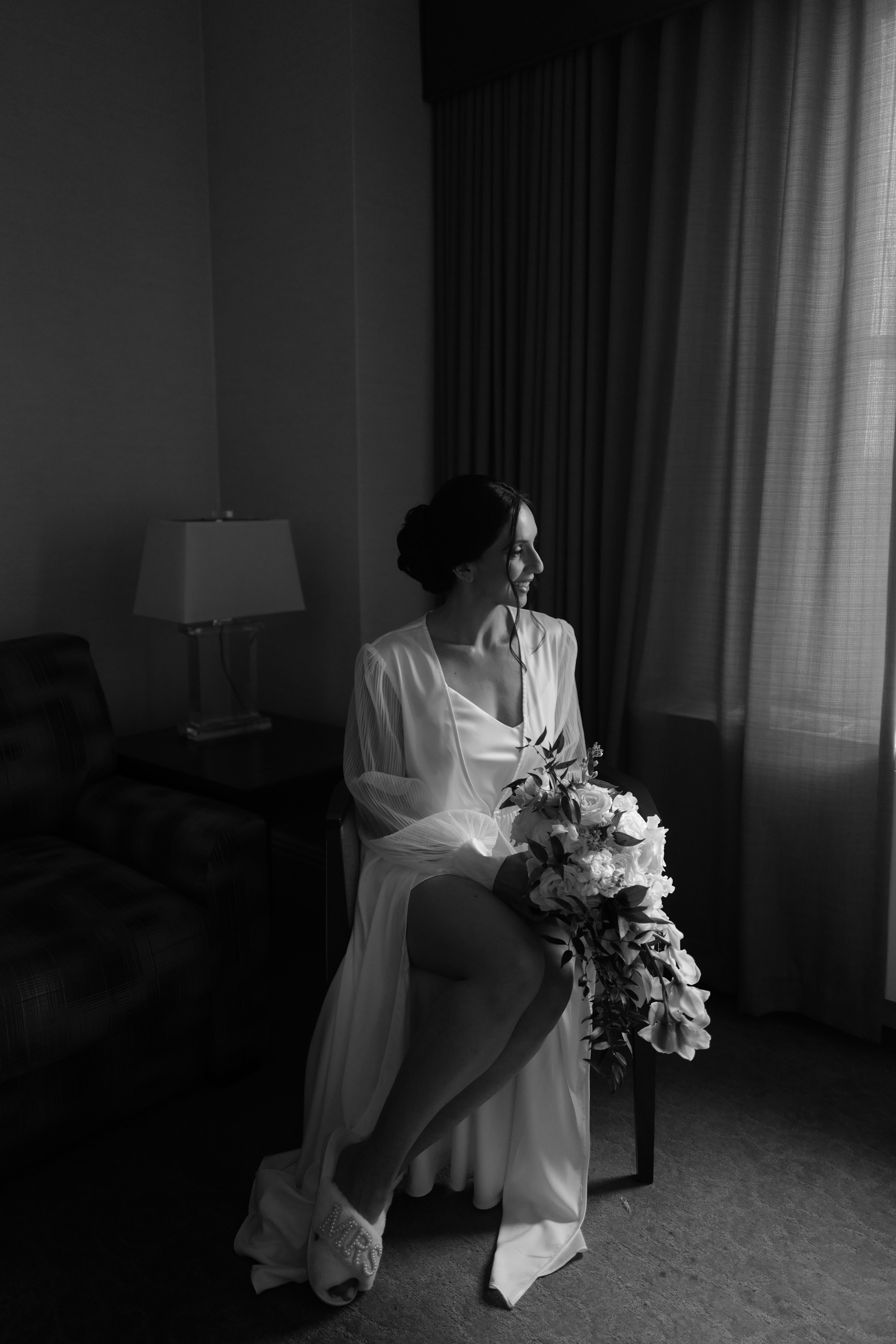 a woman in a white dress sitting on a couch