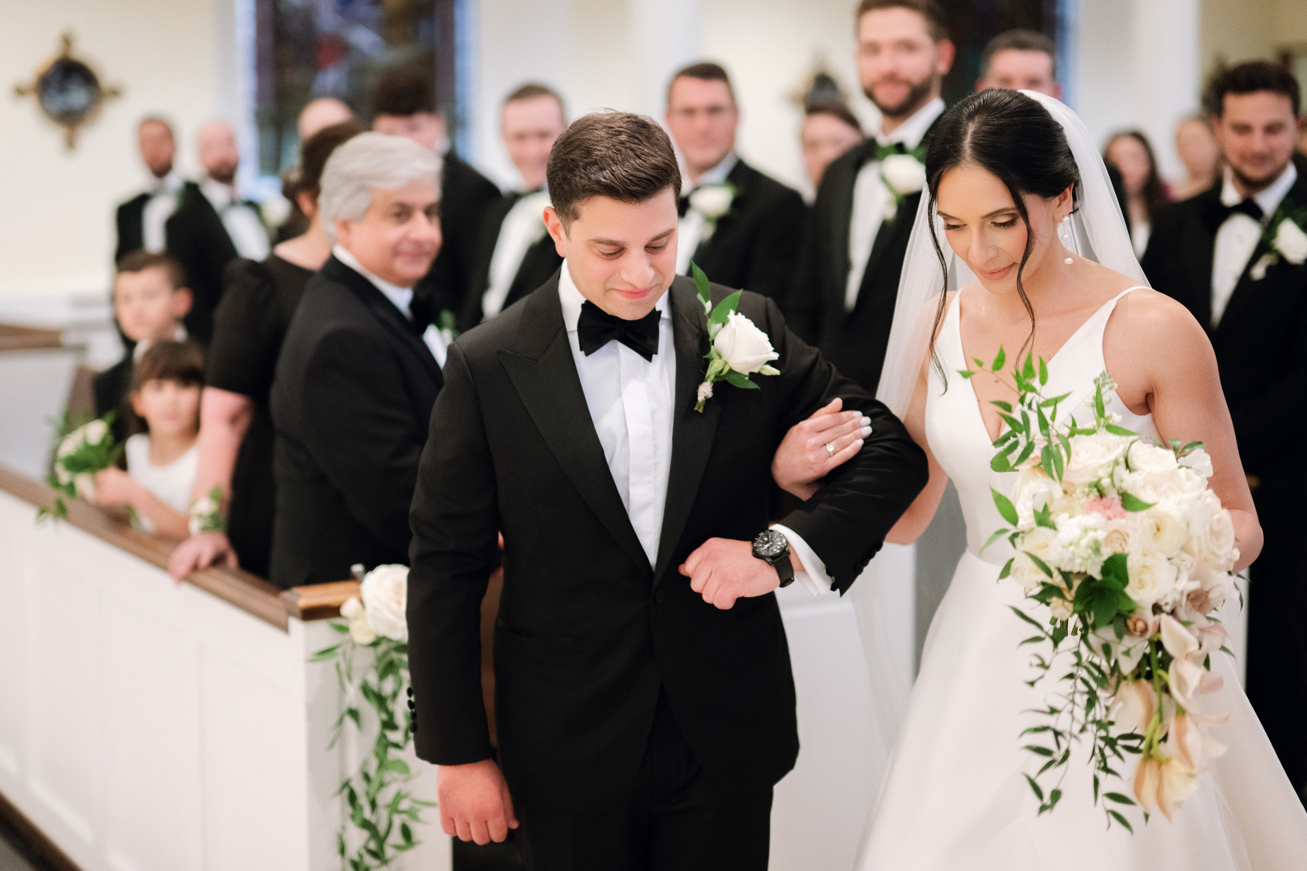 a bride and groom walking down the aisle