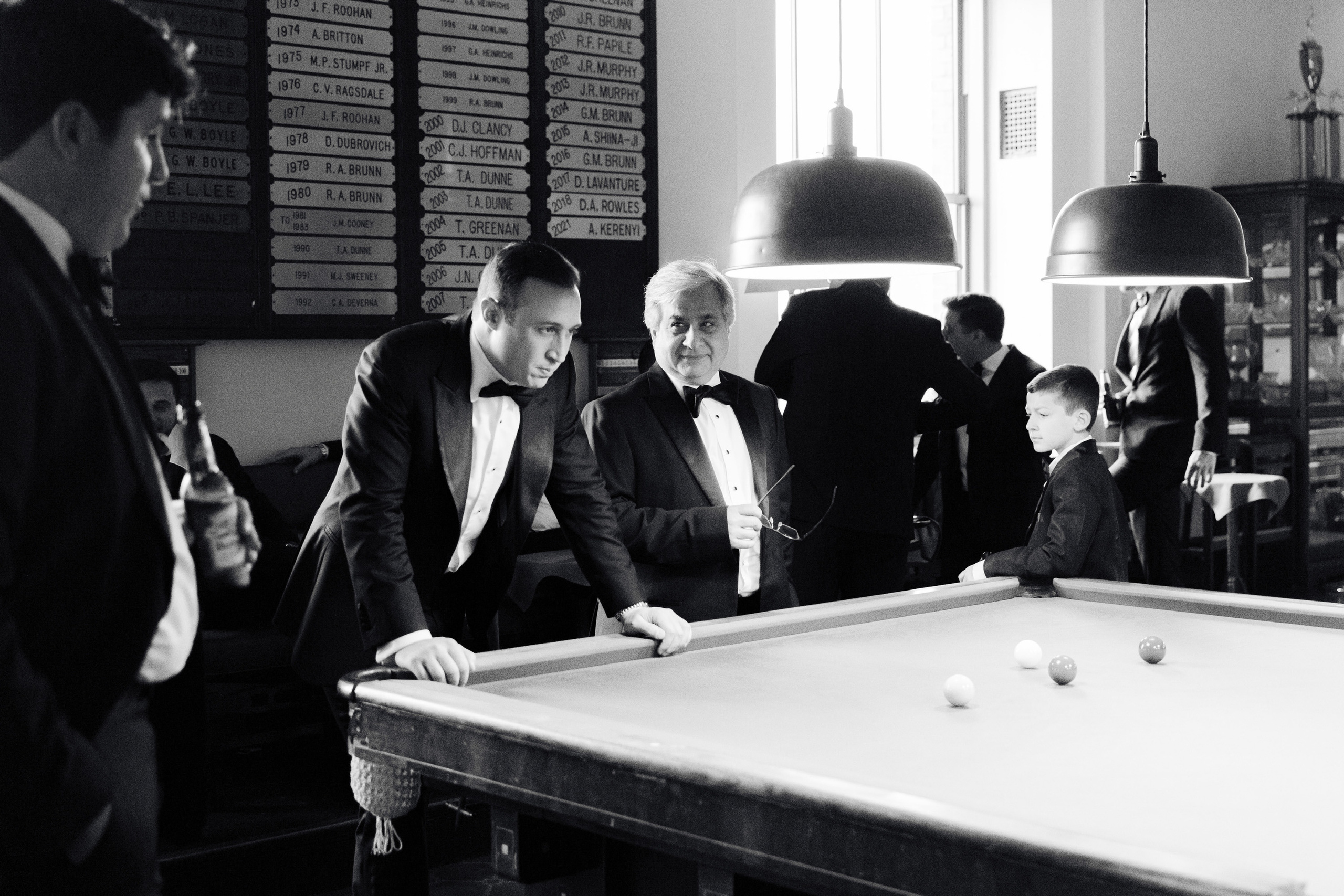 a group of men playing pool in a room