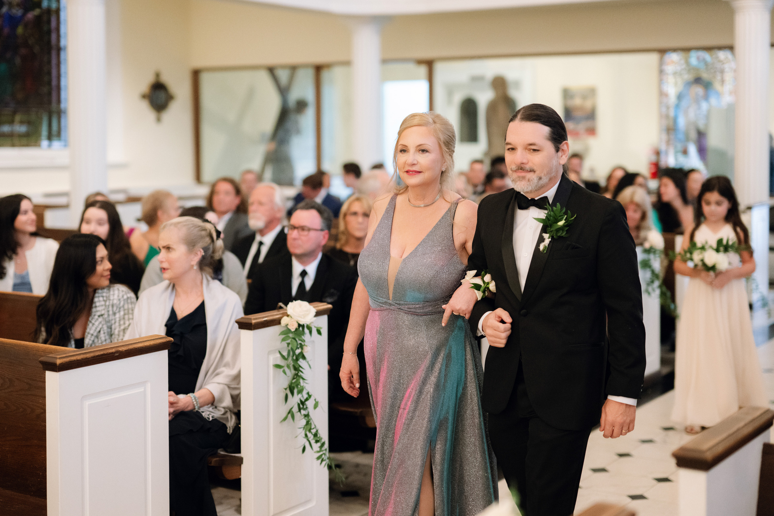a man and woman walking down the aisle