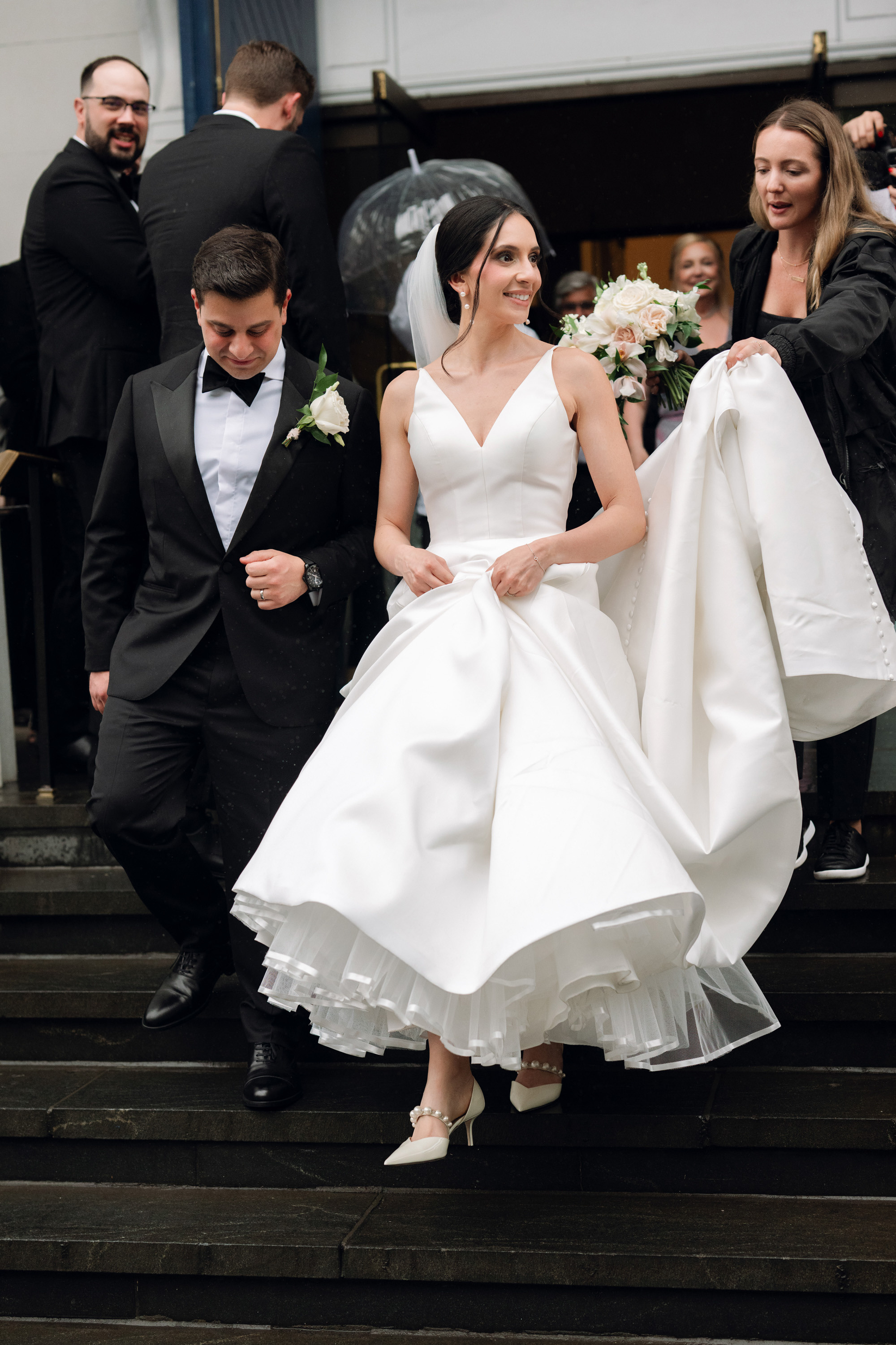 a bride and groom walking down the stairs