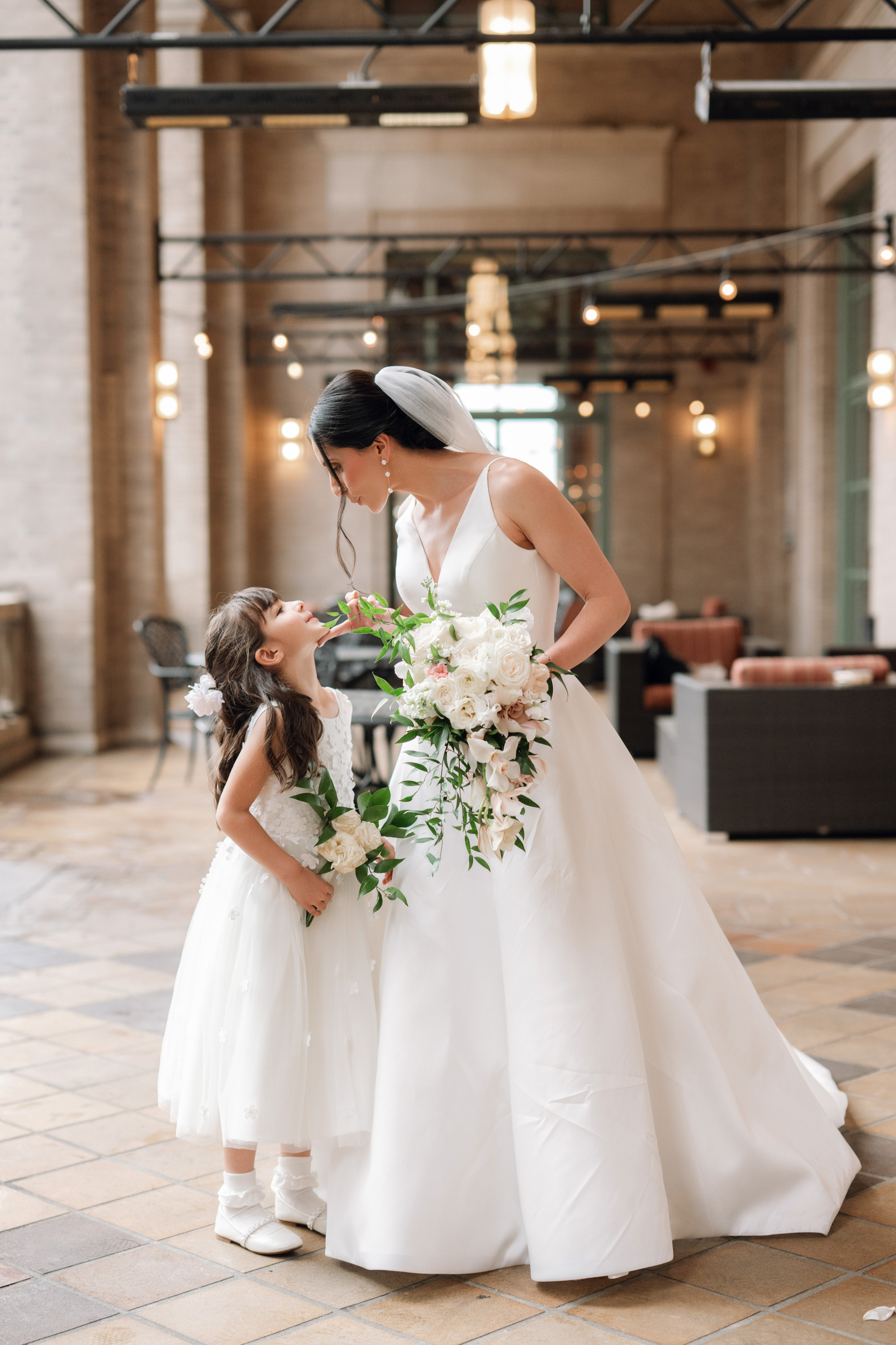 a bride and her flower girl at the wedding