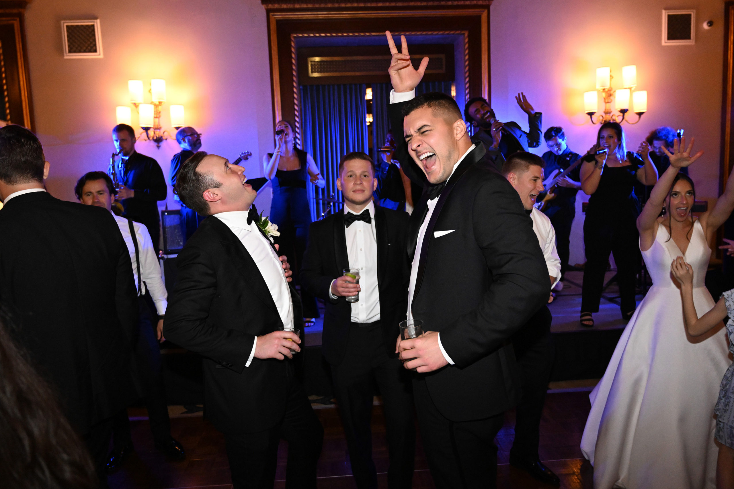 a group of people standing around a dance floor