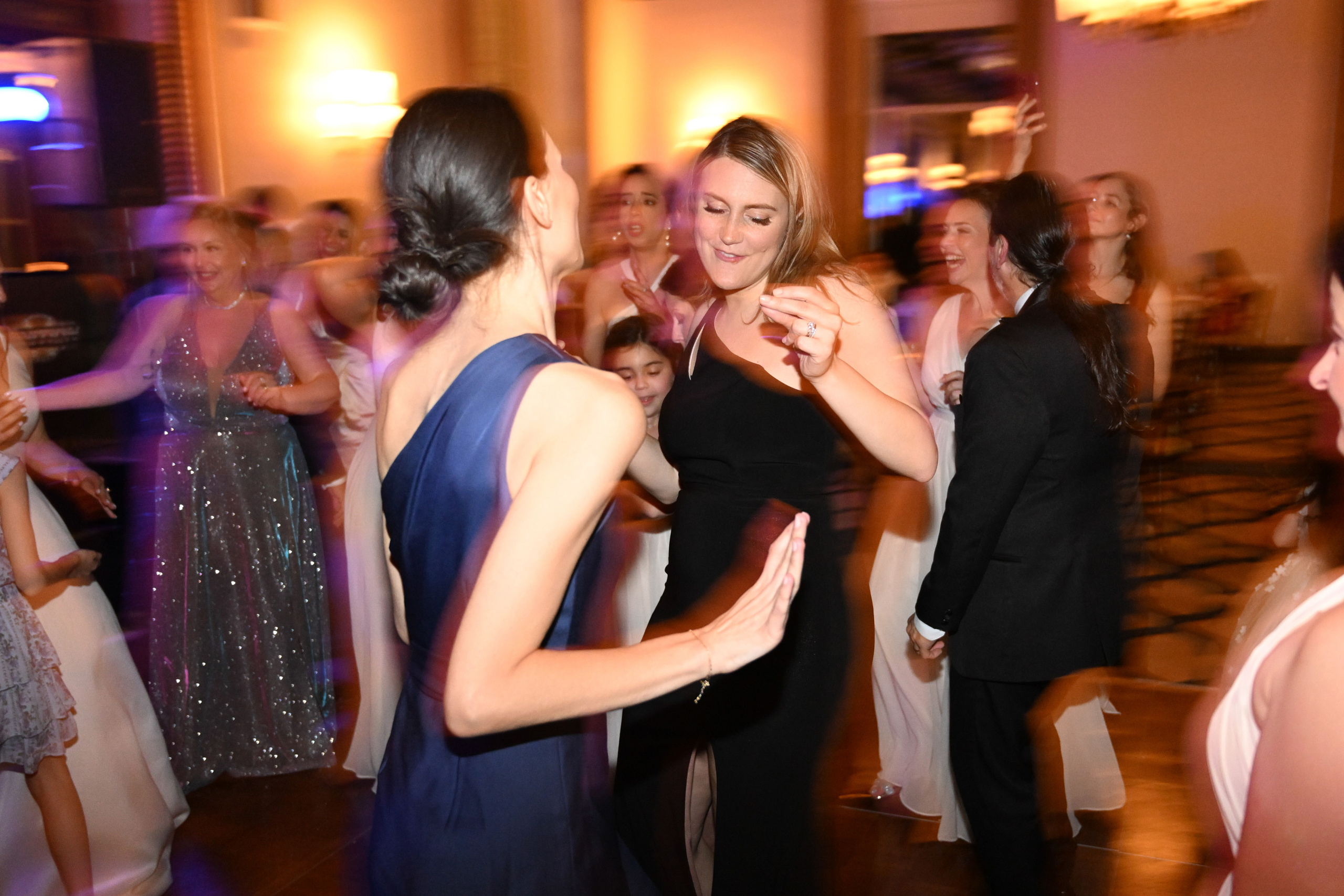 a group of people dancing at a formal event