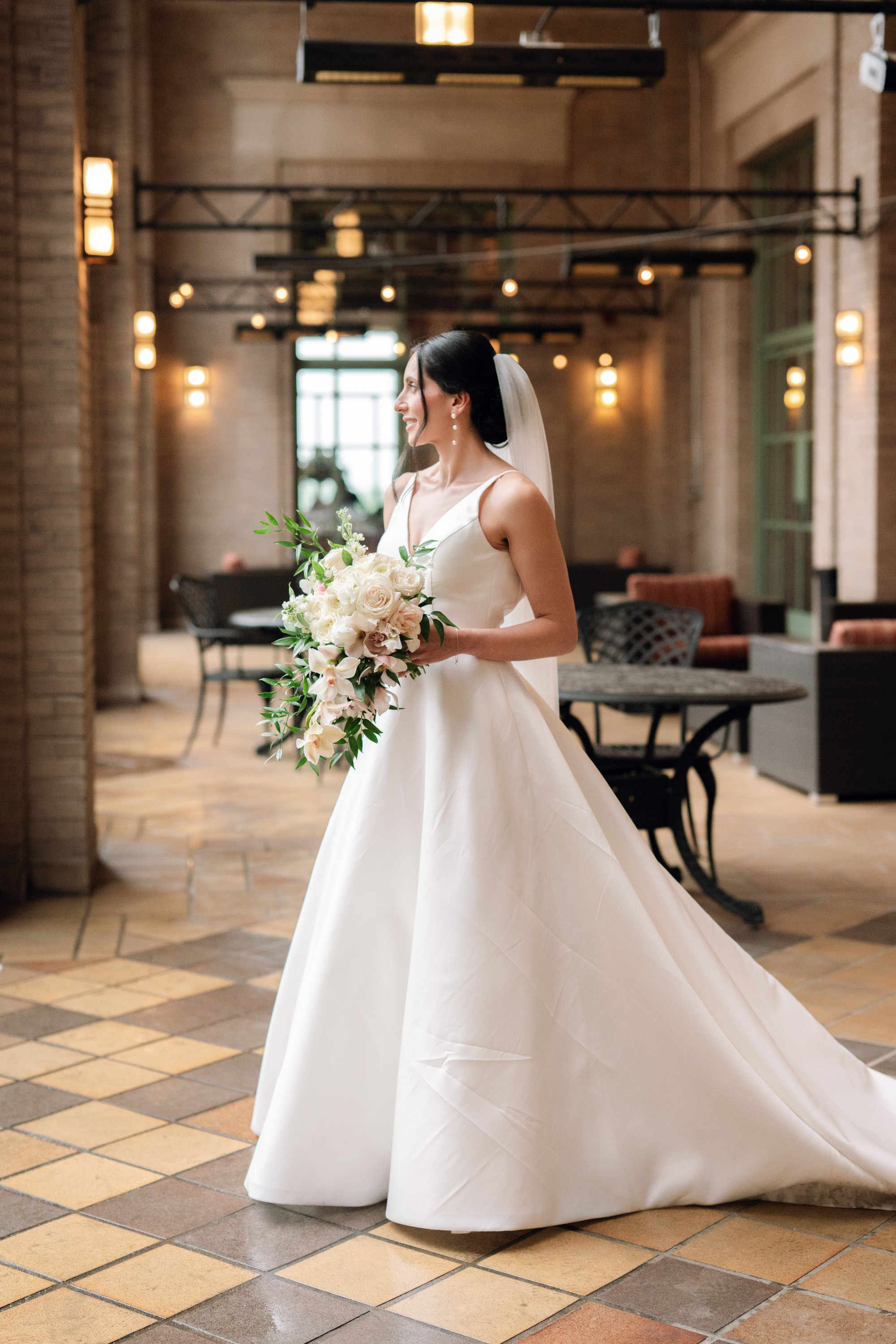 a bride in a white wedding dress holding a bouquet