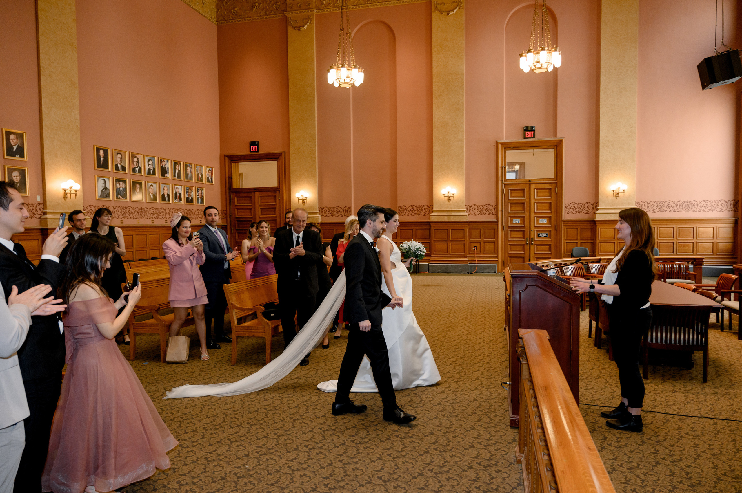 a bride and groom walking down the aisle