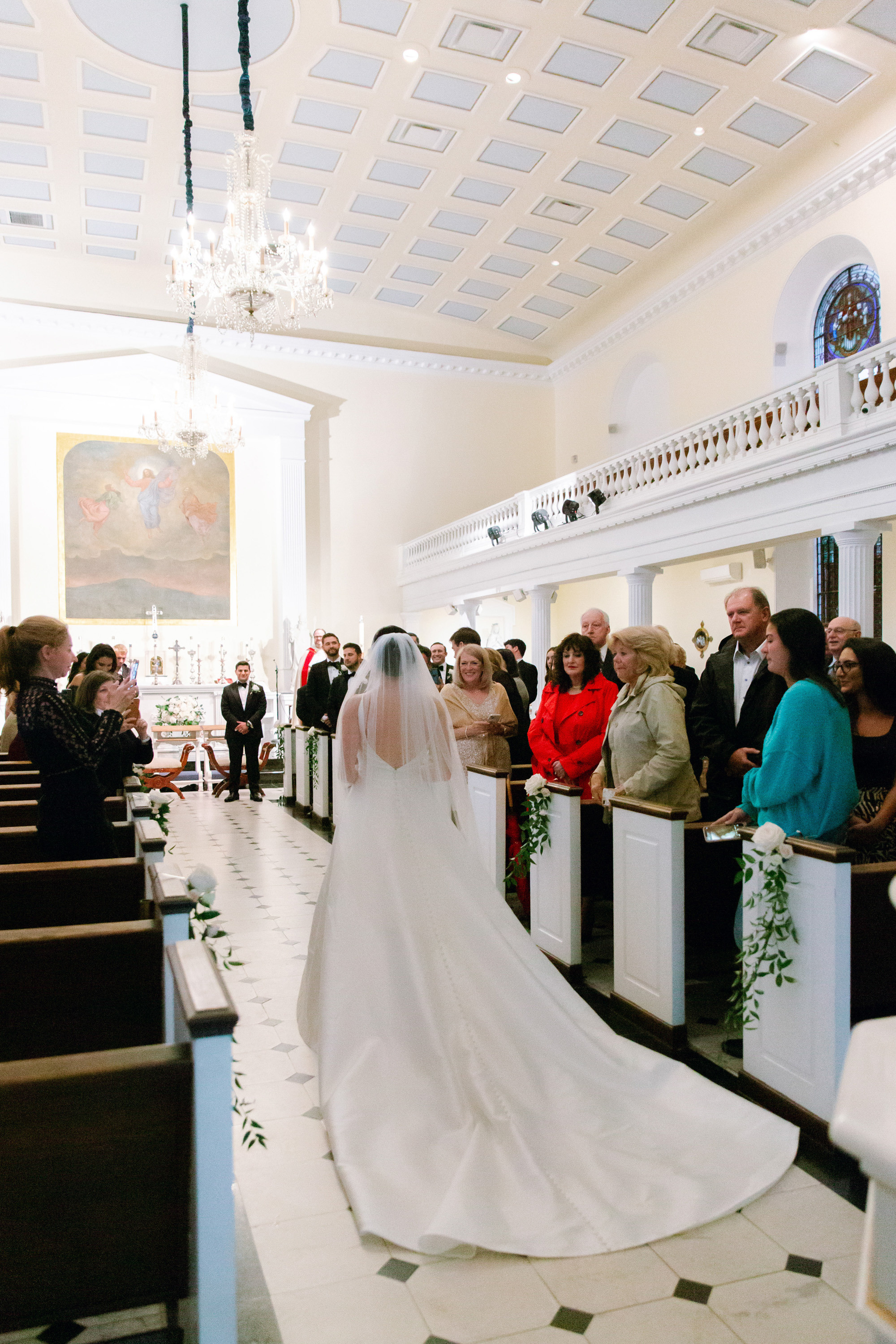 a bride walking down the aisle of a church