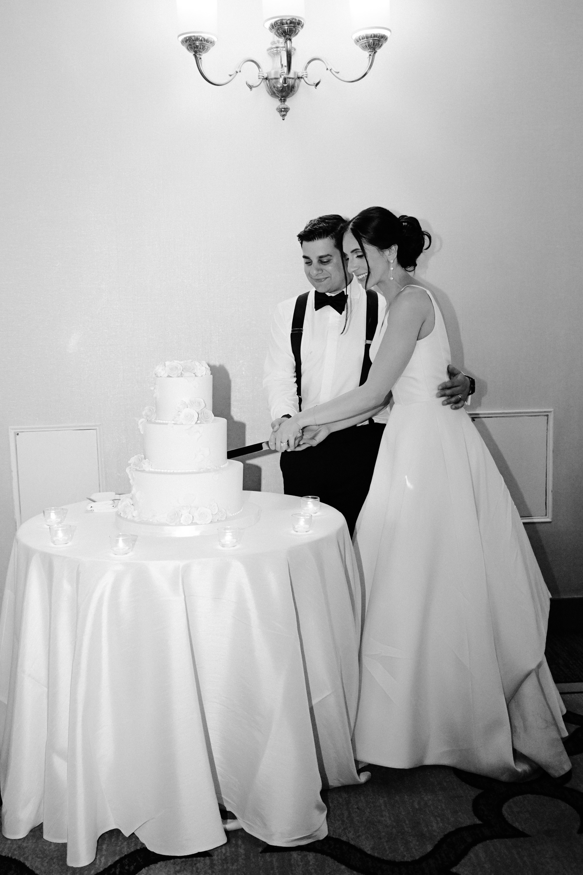 a bride and groom cutting their wedding cake