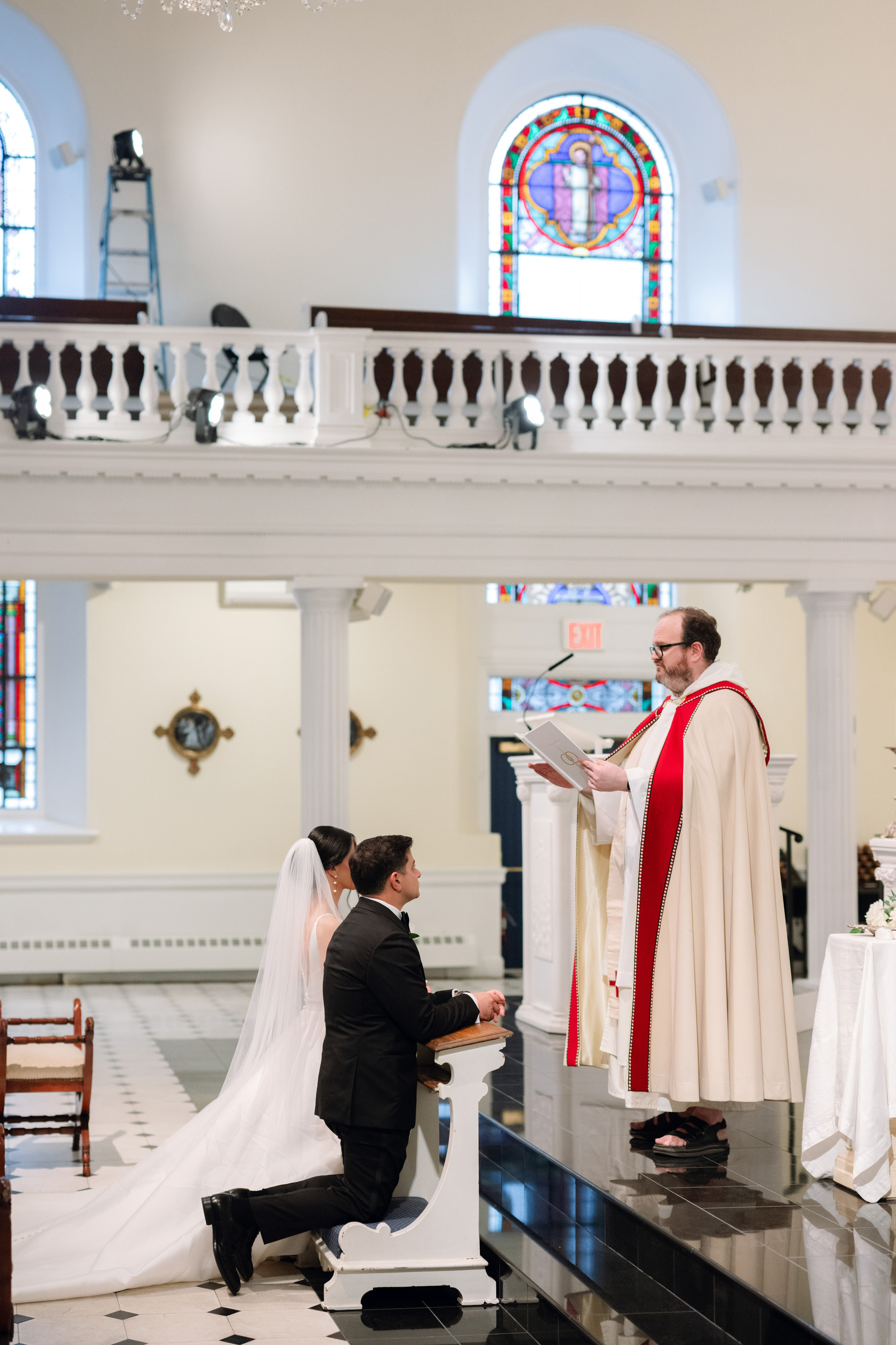 a man kneeling down to a woman in a church