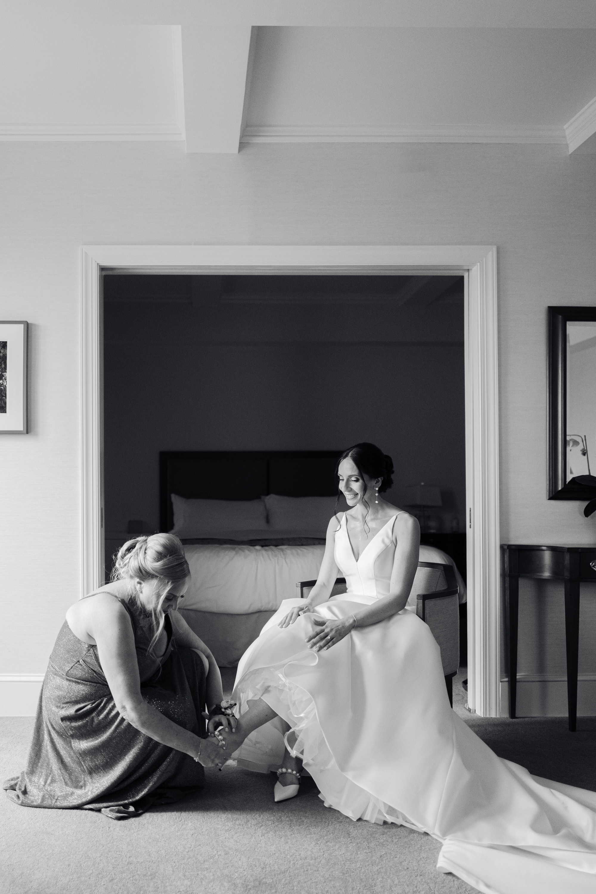a bride and her mother are sitting on the floor