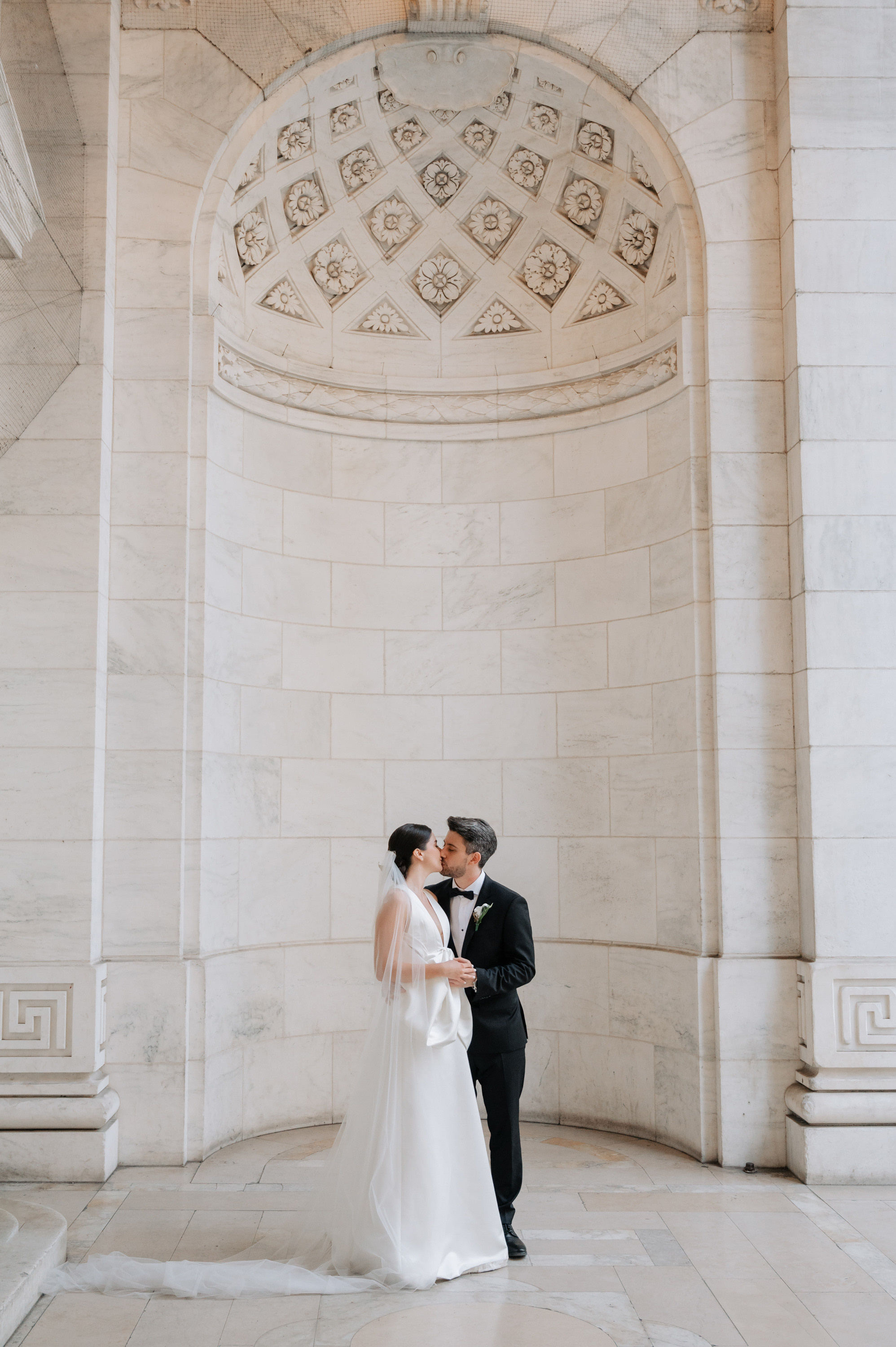 a bride and groom kissing in the rot