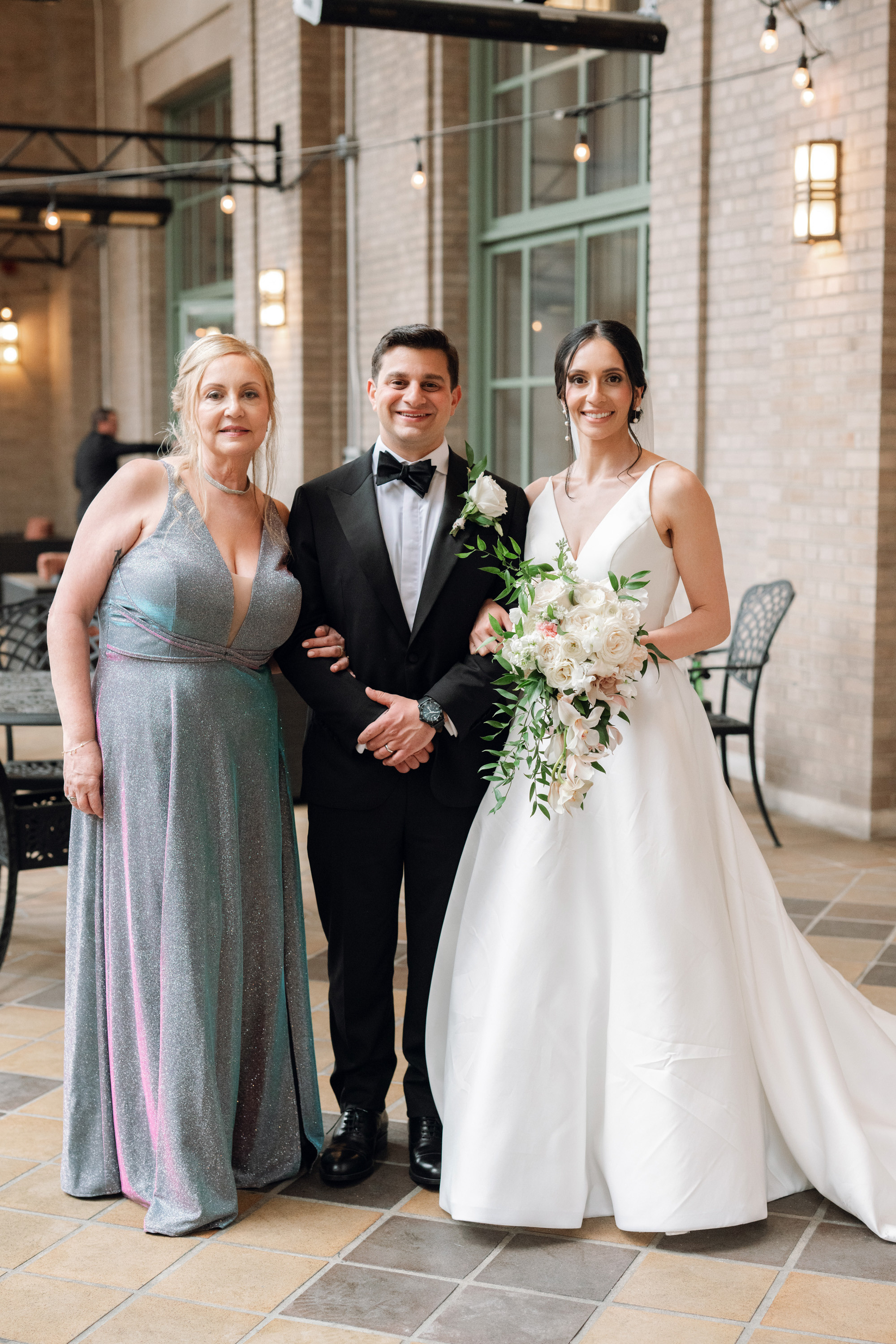 a bride and groom pose for a photo with their bridesmas