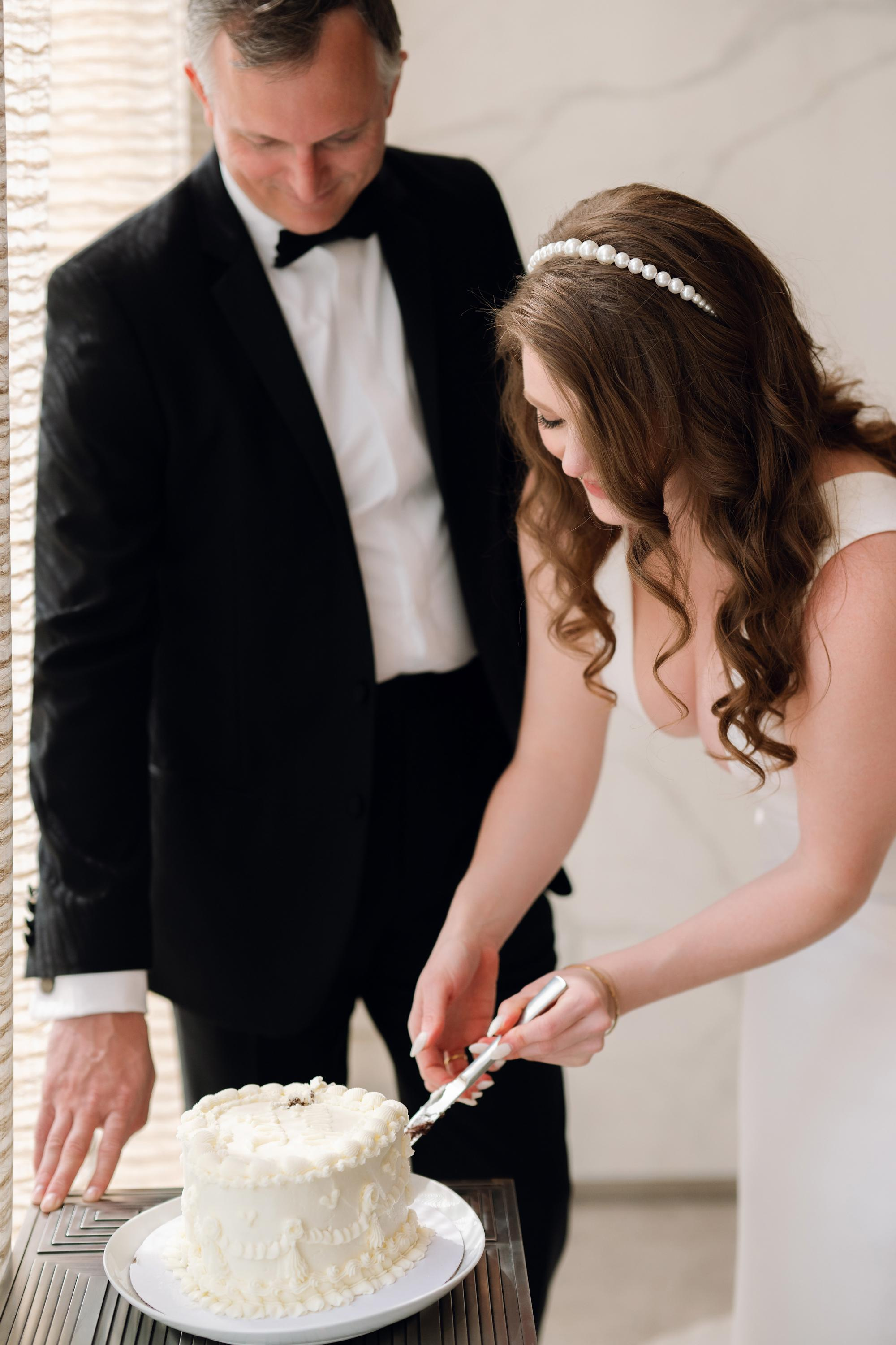 a man and woman cutting a cake together